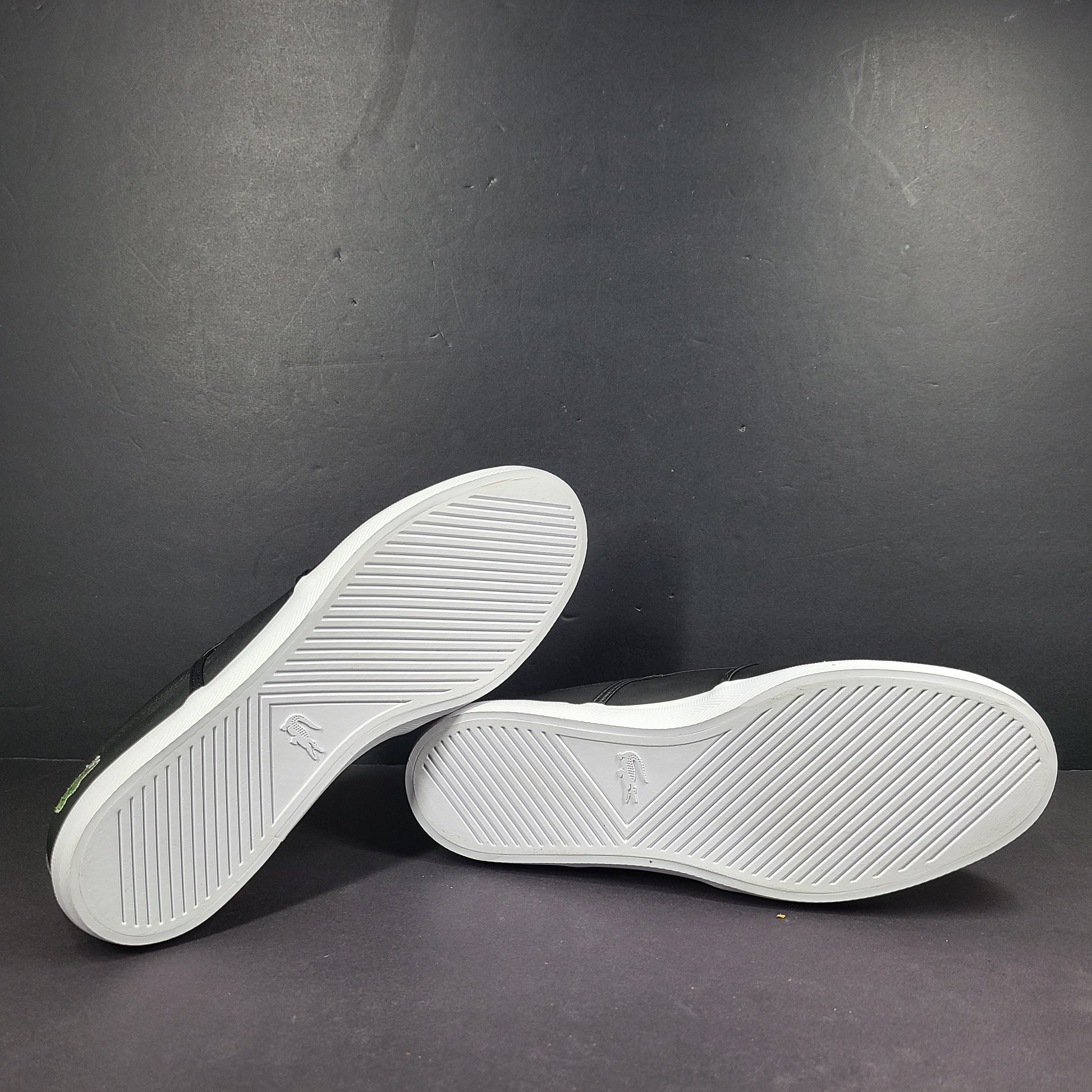 A pair of leather slip-on sneakers by Lacoste.