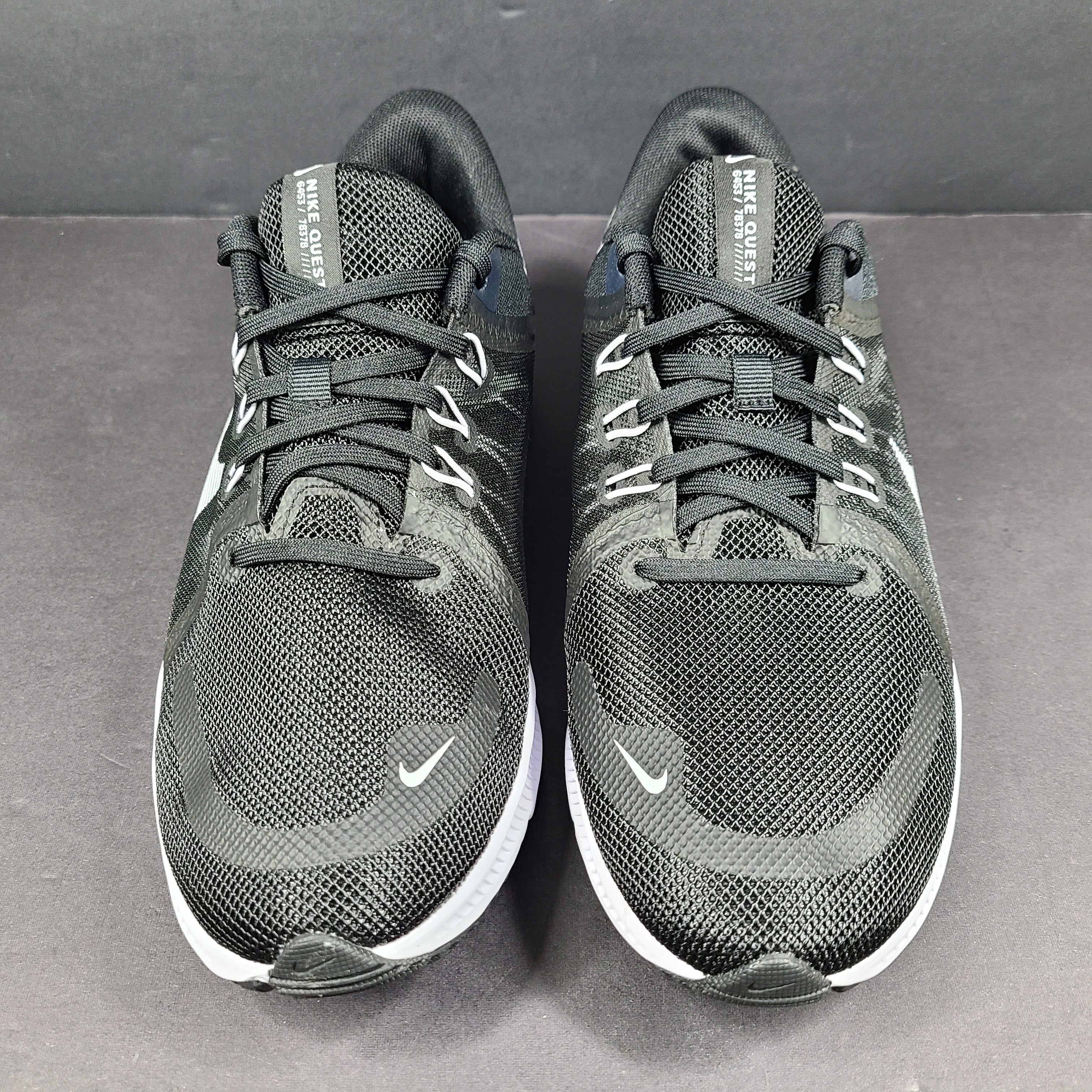Sleek black Nike Quest 4 running shoes deliver lightweight cushioning and a streamlined fit for daily road runs.