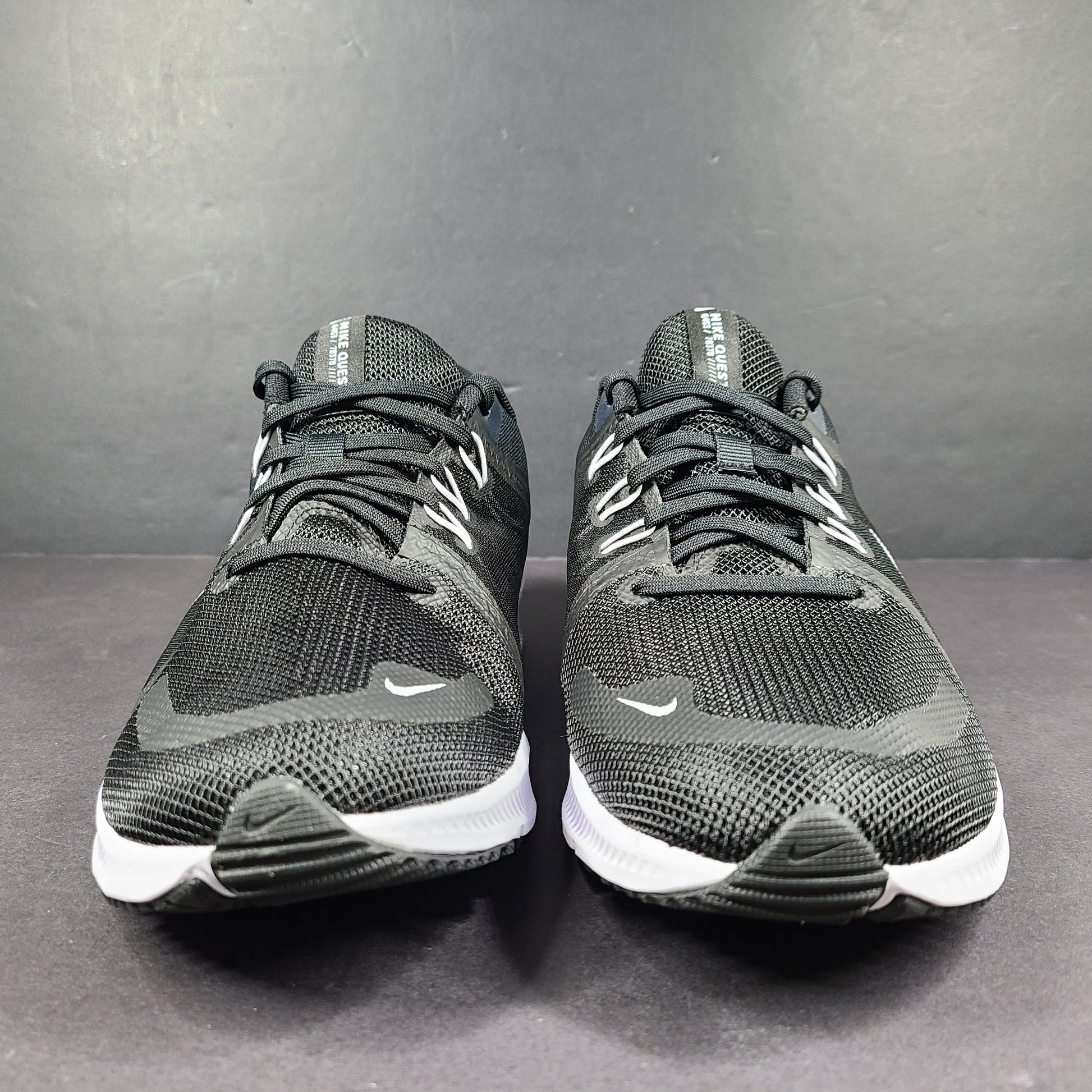 Sleek black Nike Quest 4 running shoes deliver lightweight cushioning and a streamlined fit for daily road runs.