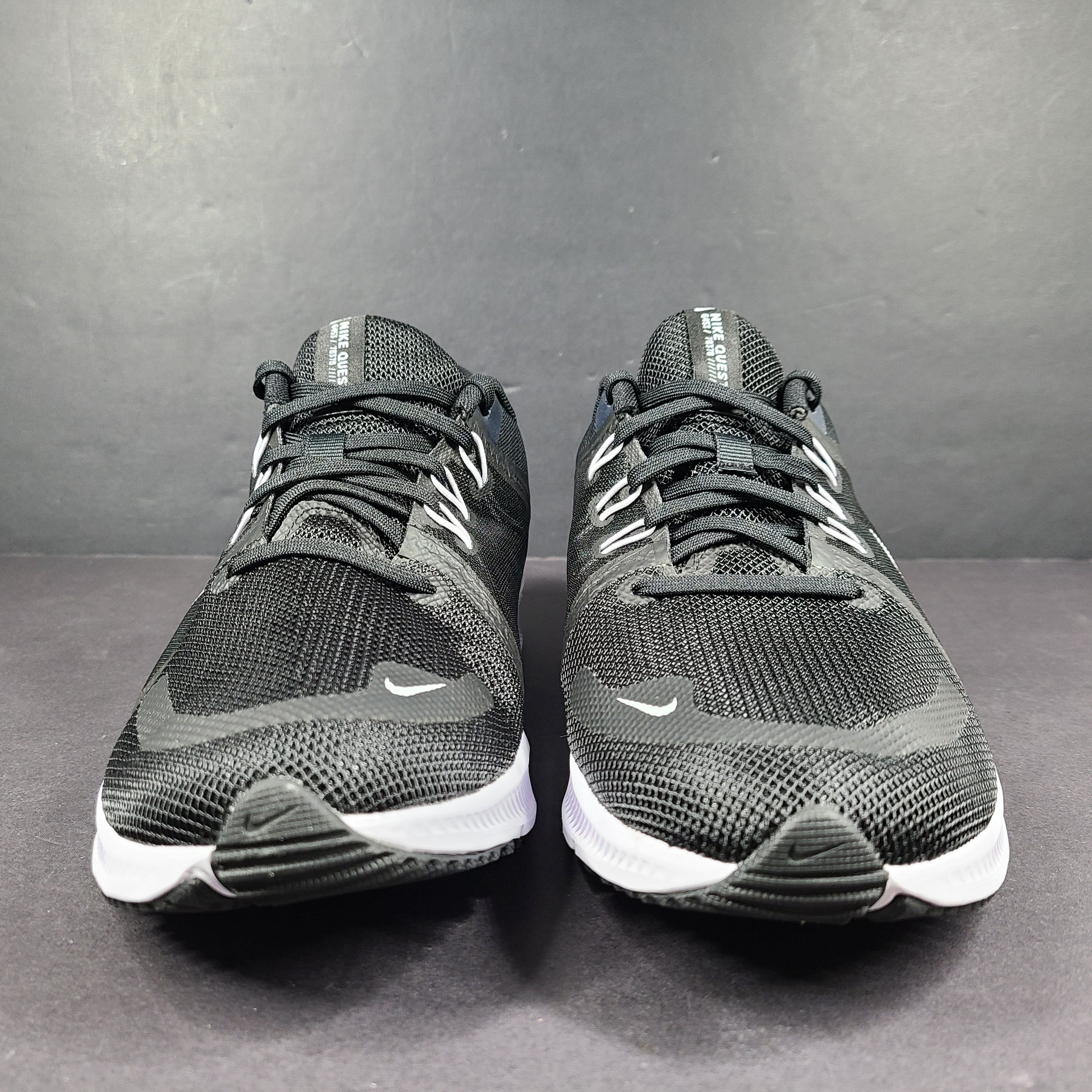Sleek black Nike Quest 4 running shoes deliver lightweight cushioning and a streamlined fit for daily road runs.
