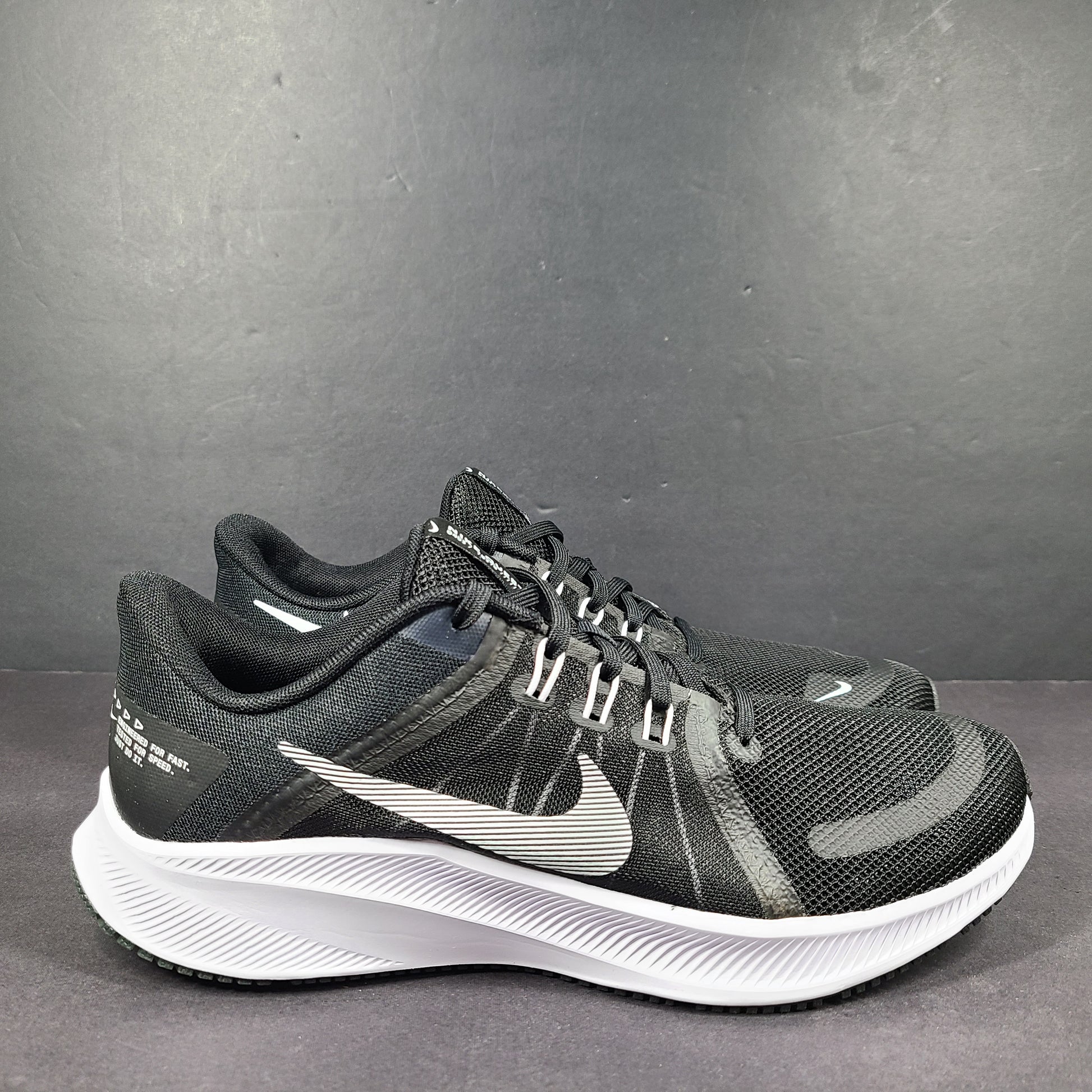 Sleek black Nike Quest 4 running shoes deliver lightweight cushioning and a streamlined fit for daily road runs.