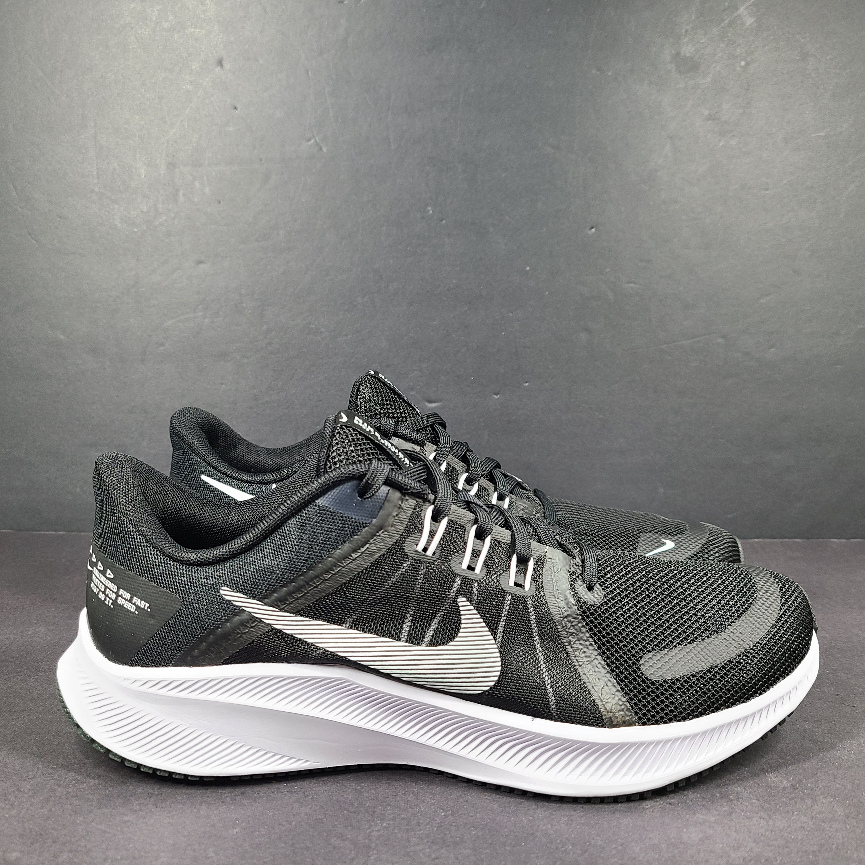 Sleek black Nike Quest 4 running shoes deliver lightweight cushioning and a streamlined fit for daily road runs.