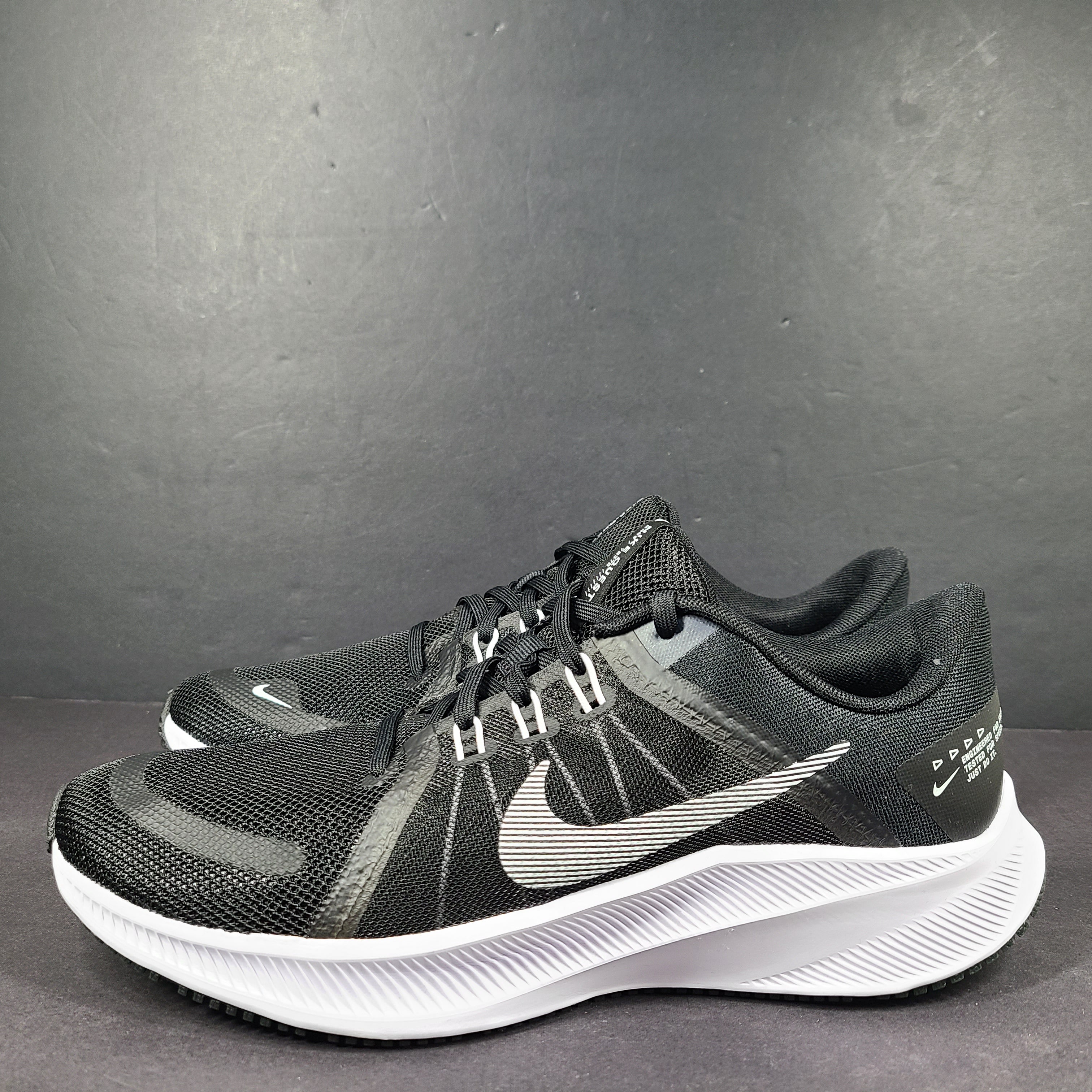 Sleek black Nike Quest 4 running shoes deliver lightweight cushioning and a streamlined fit for daily road runs.