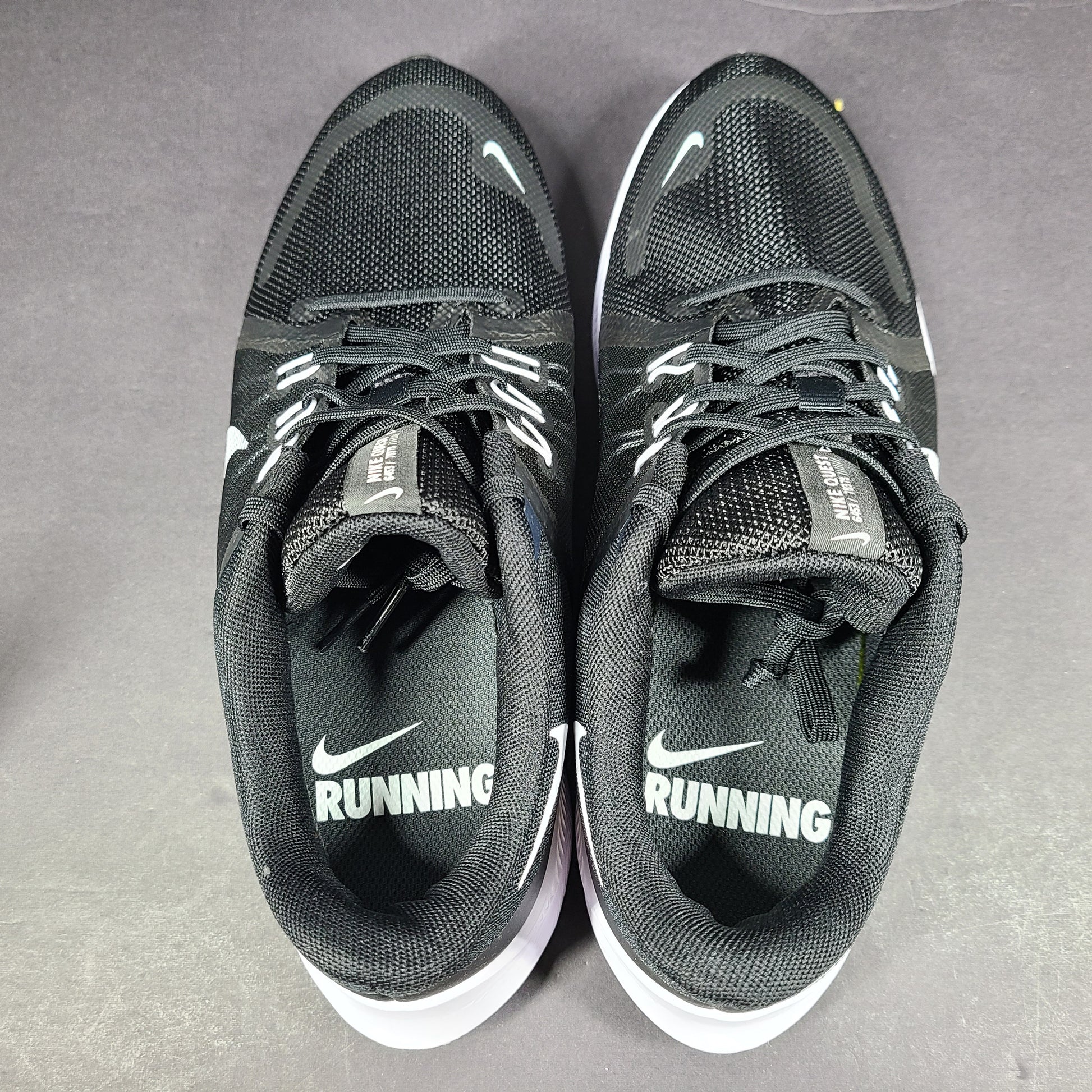 Sleek black Nike Quest 4 running shoes deliver lightweight cushioning and a streamlined fit for daily road runs.