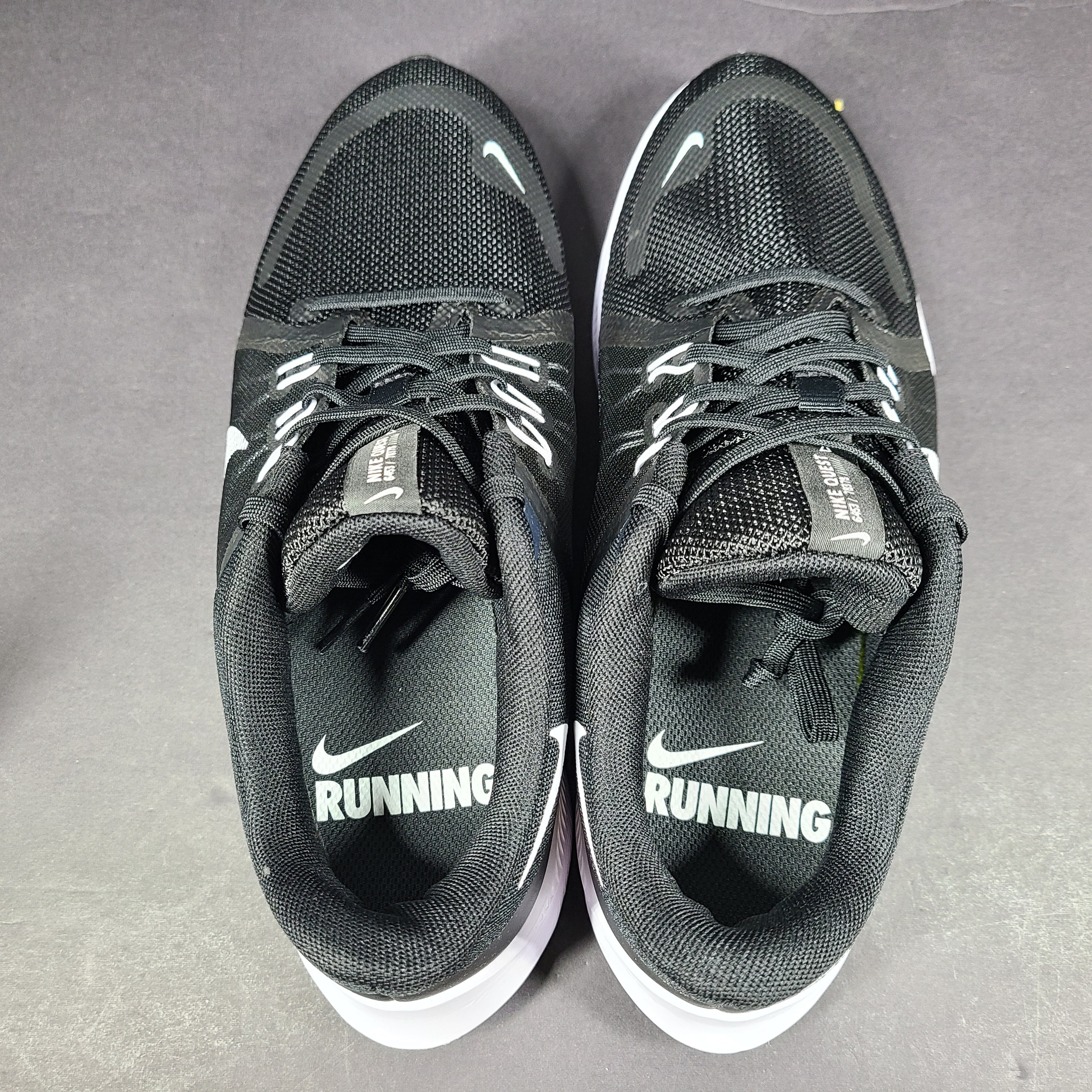 Sleek black Nike Quest 4 running shoes deliver lightweight cushioning and a streamlined fit for daily road runs.