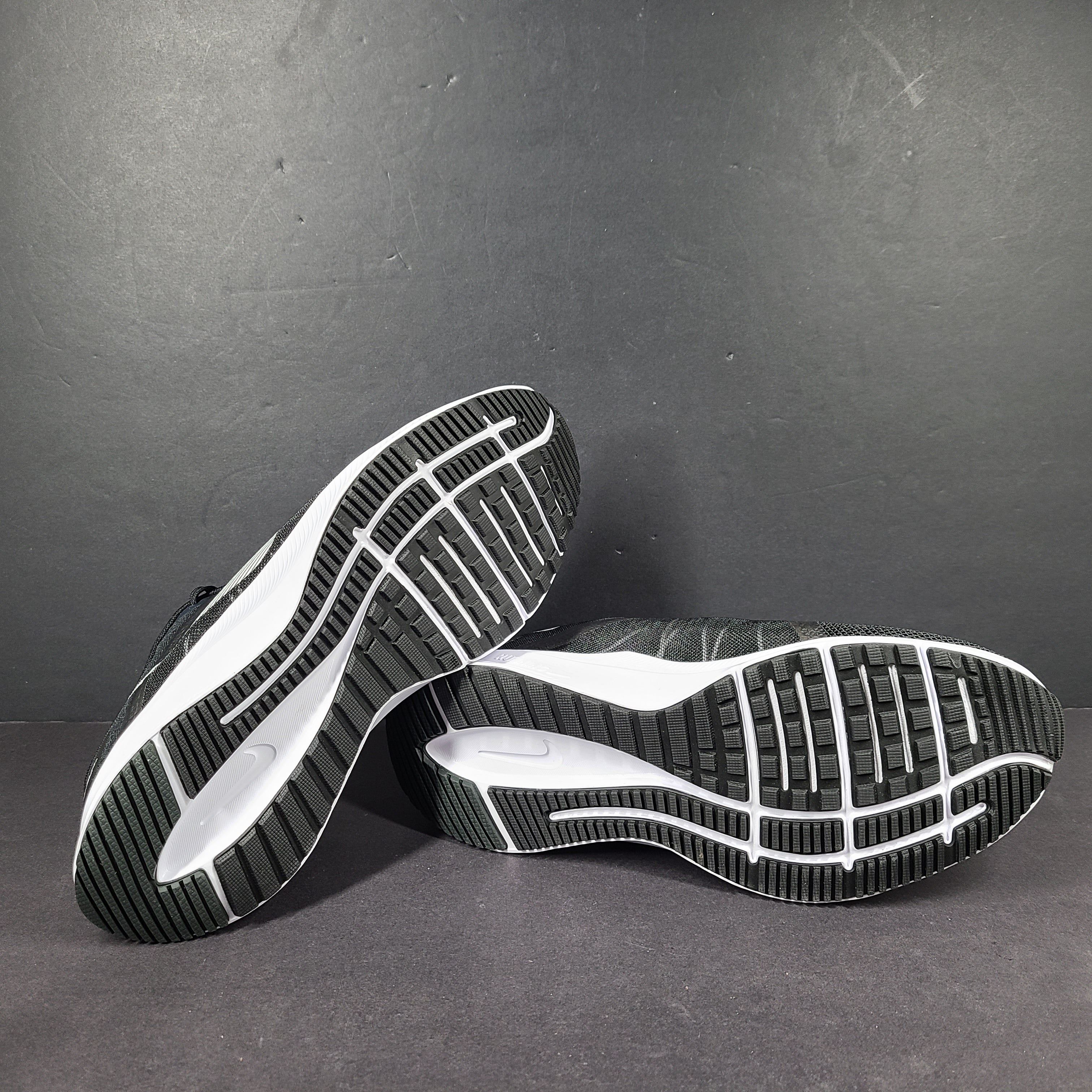 Sleek black Nike Quest 4 running shoes deliver lightweight cushioning and a streamlined fit for daily road runs.