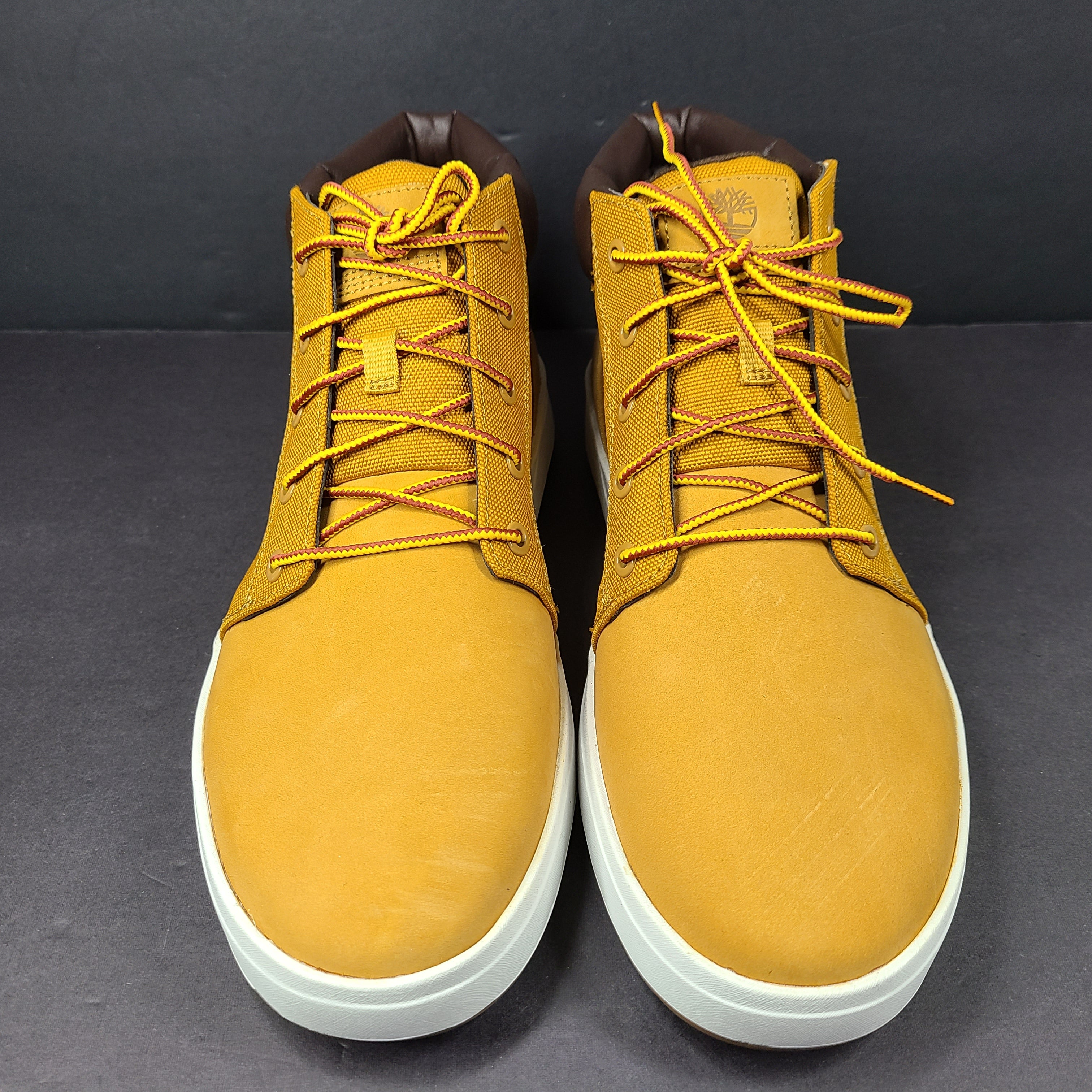 A pair of Timberland men’s sneakers in yellow and brown color.