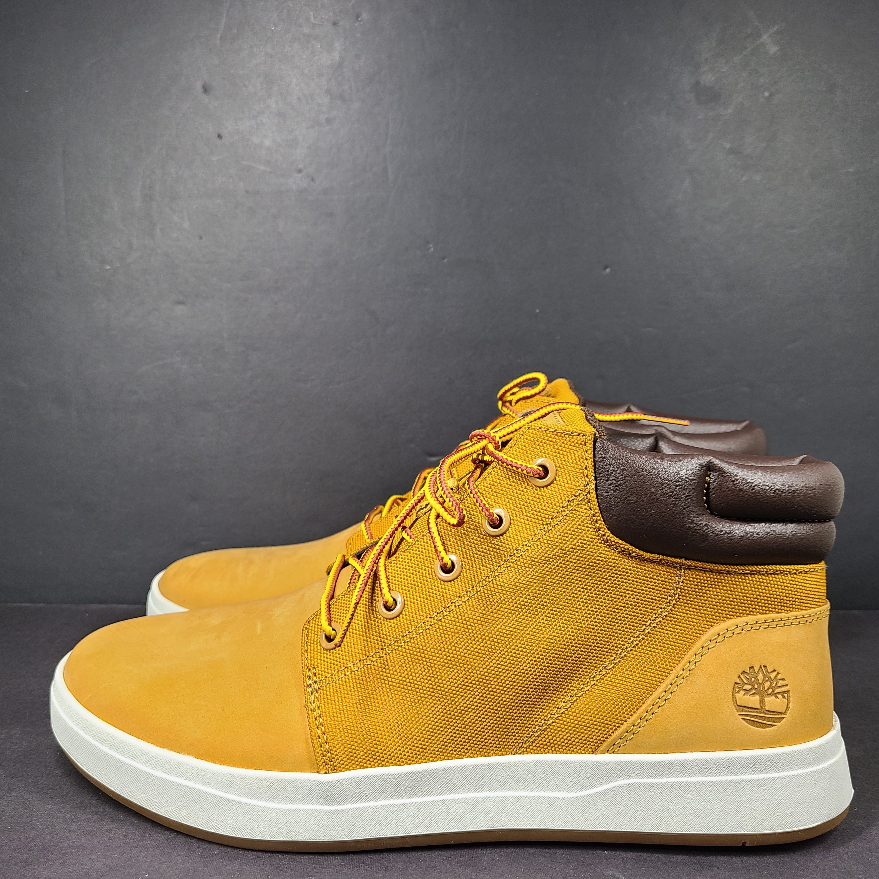 A pair of Timberland men’s sneakers in yellow and brown color.