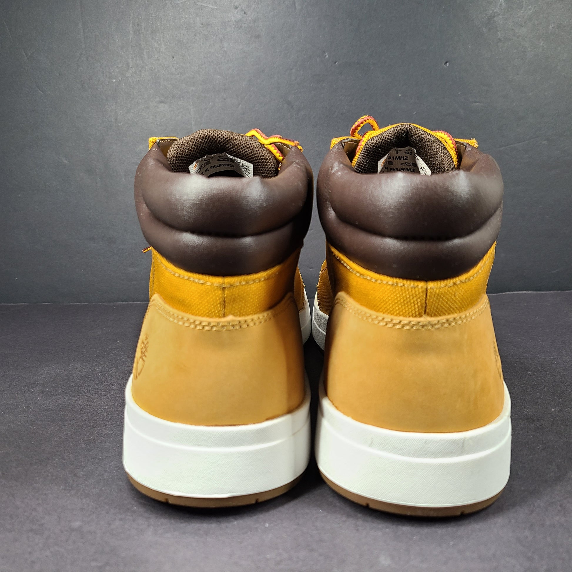 A pair of Timberland men’s sneakers in yellow and brown color.