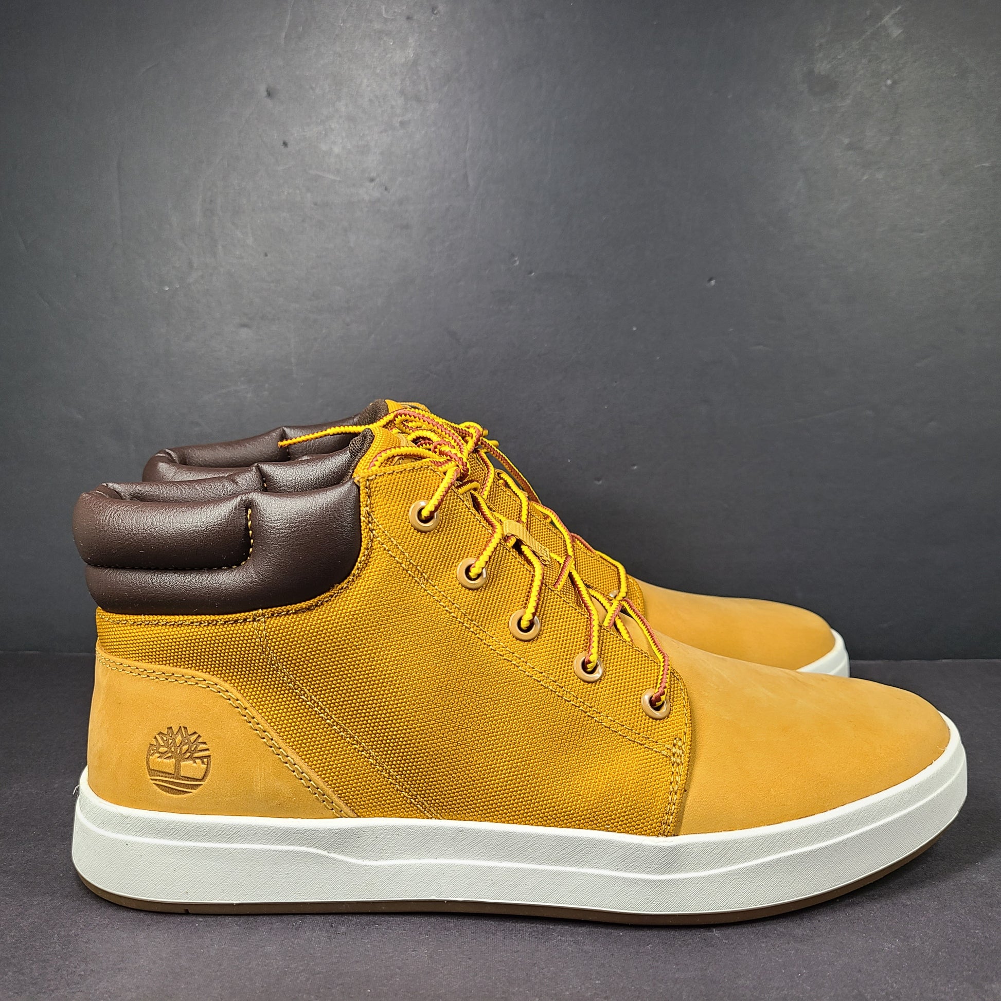 A pair of Timberland men’s sneakers in yellow and brown color.