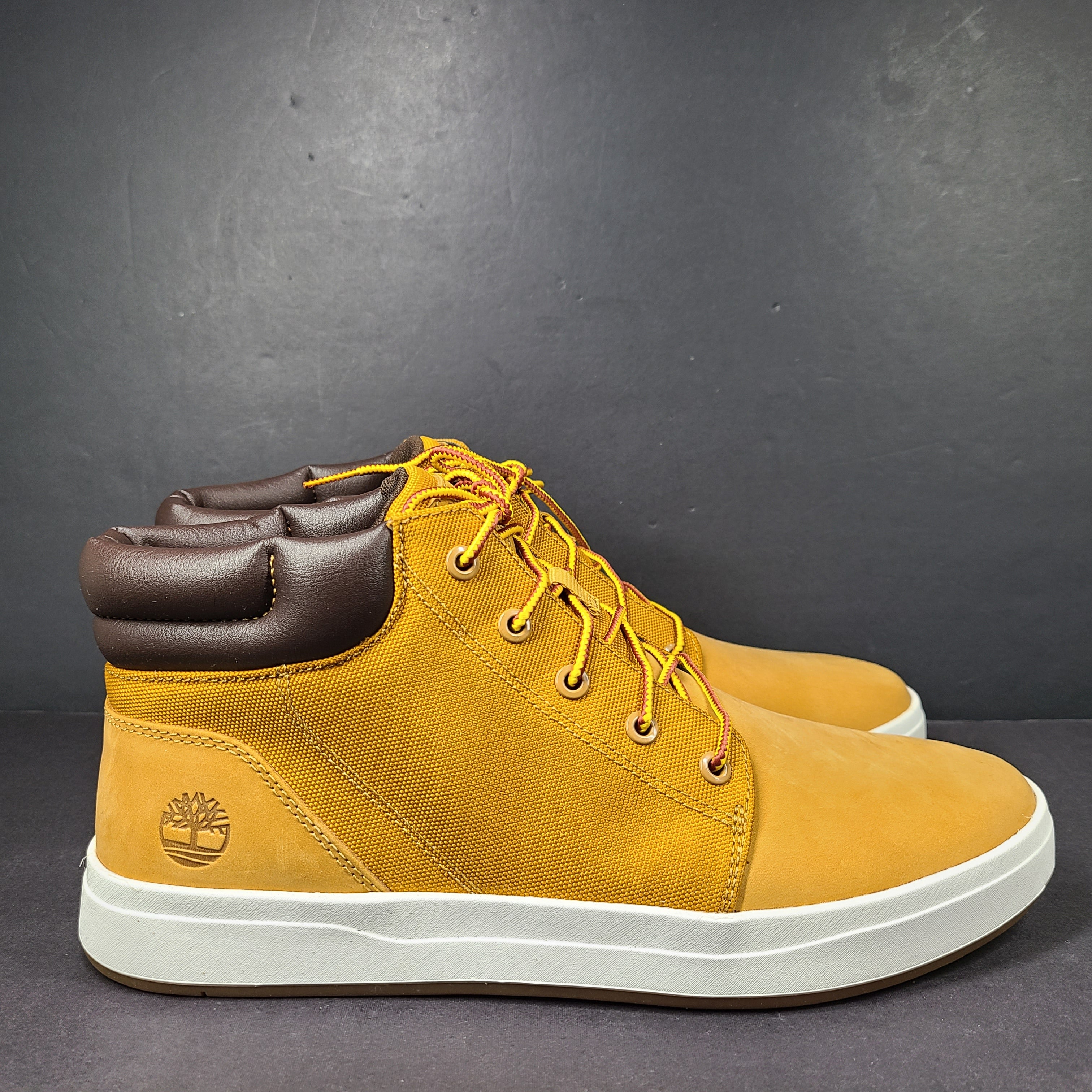 A pair of Timberland men’s sneakers in yellow and brown color.