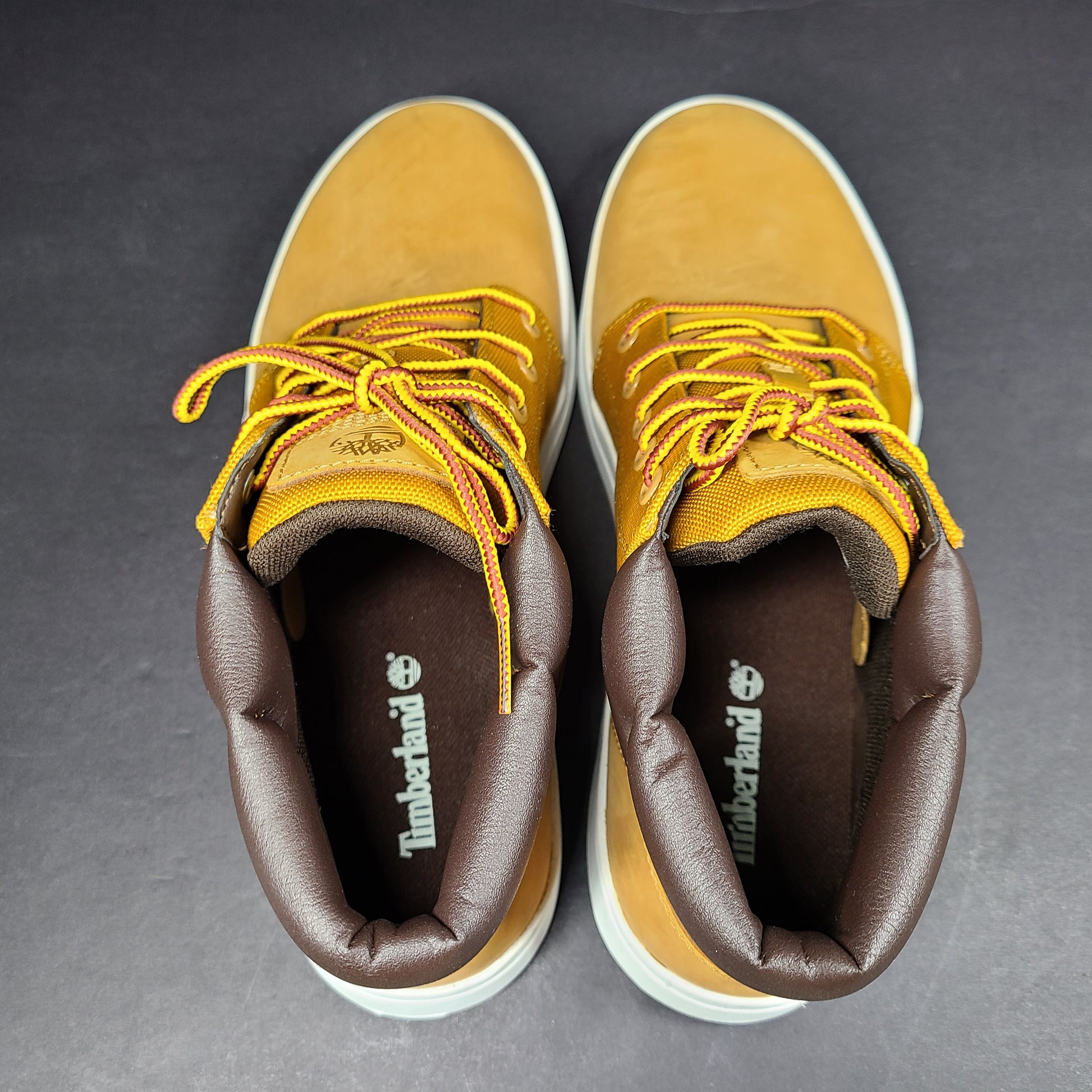 A pair of Timberland men’s sneakers in yellow and brown color.