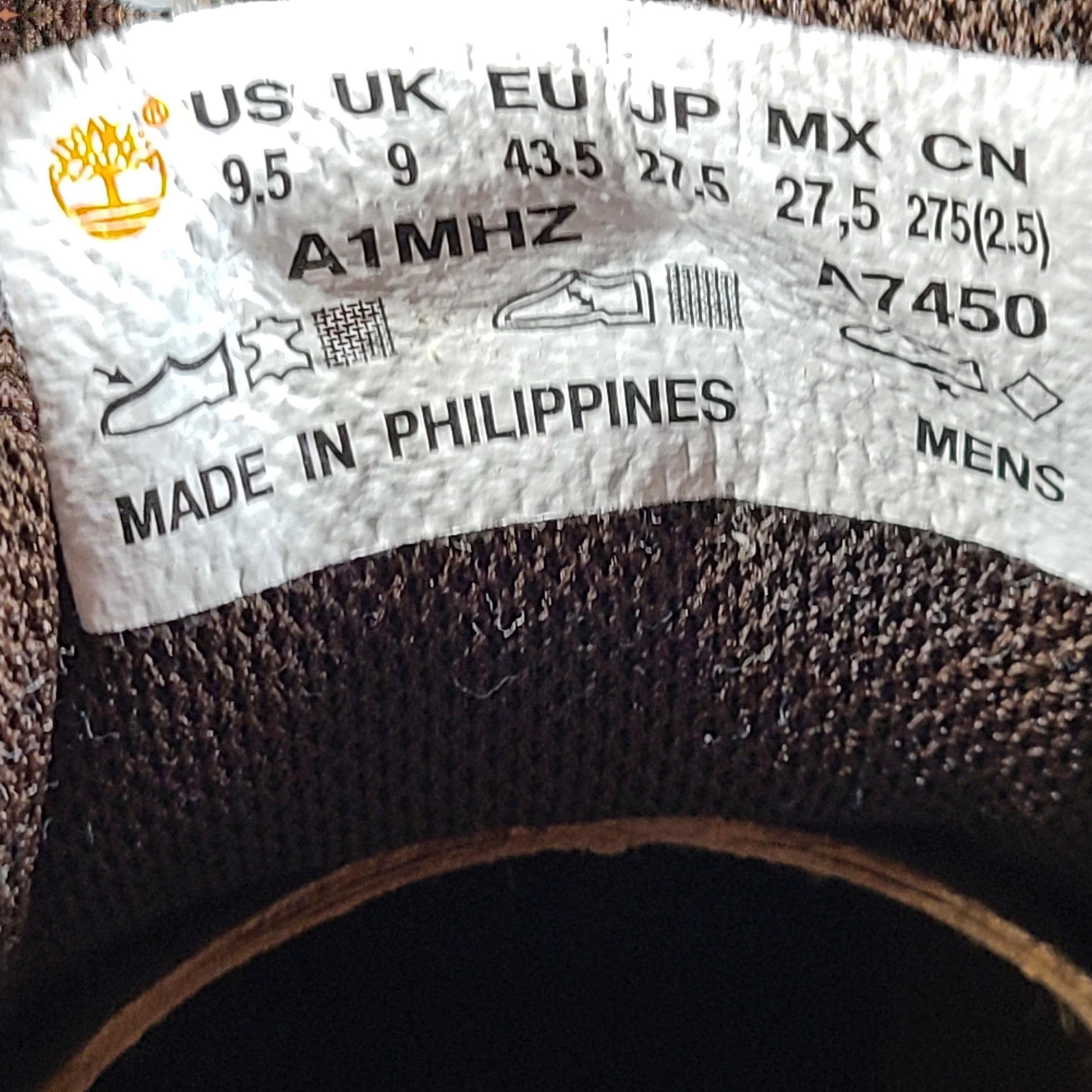 A pair of Timberland men’s sneakers in yellow and brown color.
