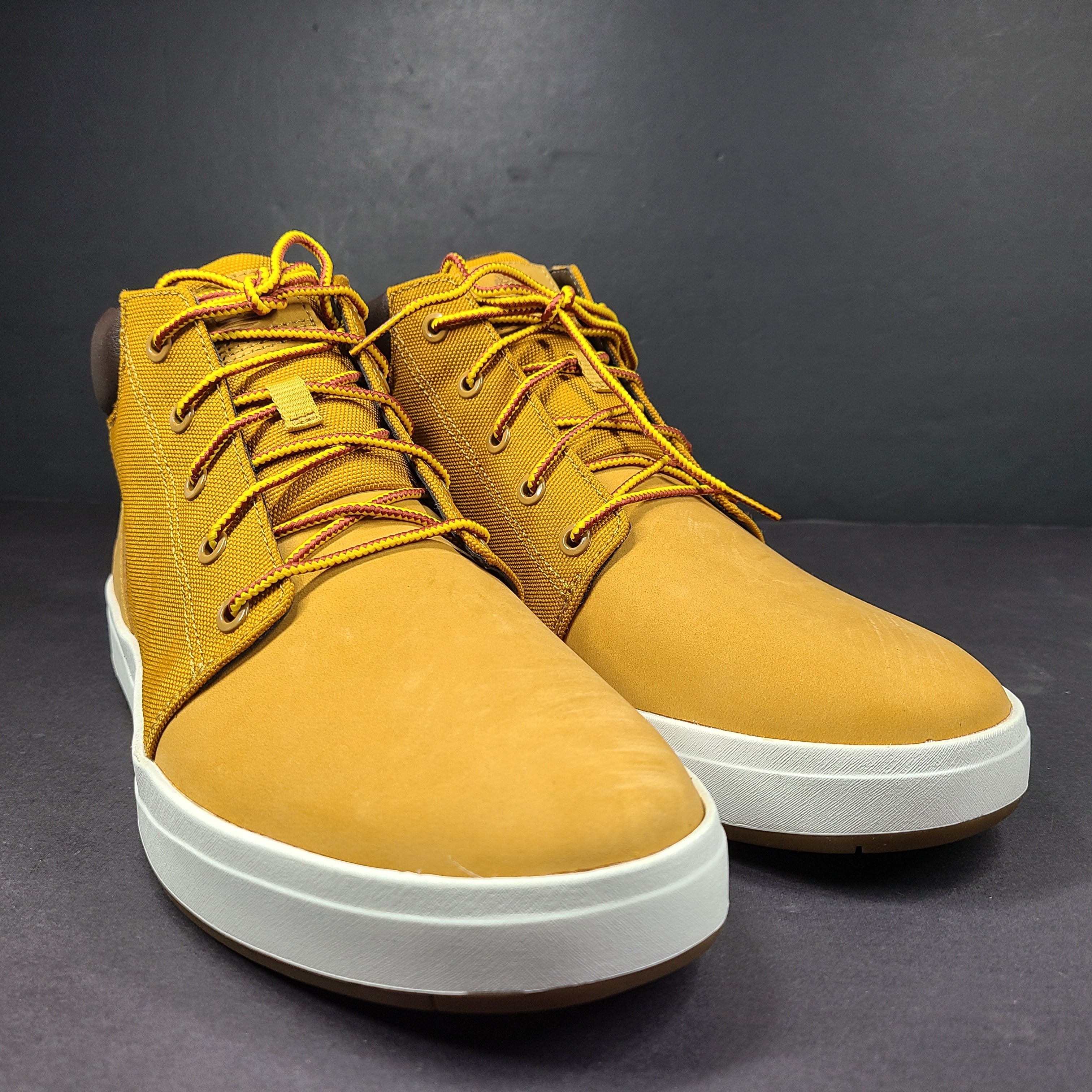 A pair of Timberland men’s sneakers in yellow and brown color.
