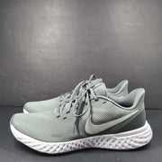 A pair of Nike Revolution 5 Men's Running Shoes in grey and white.