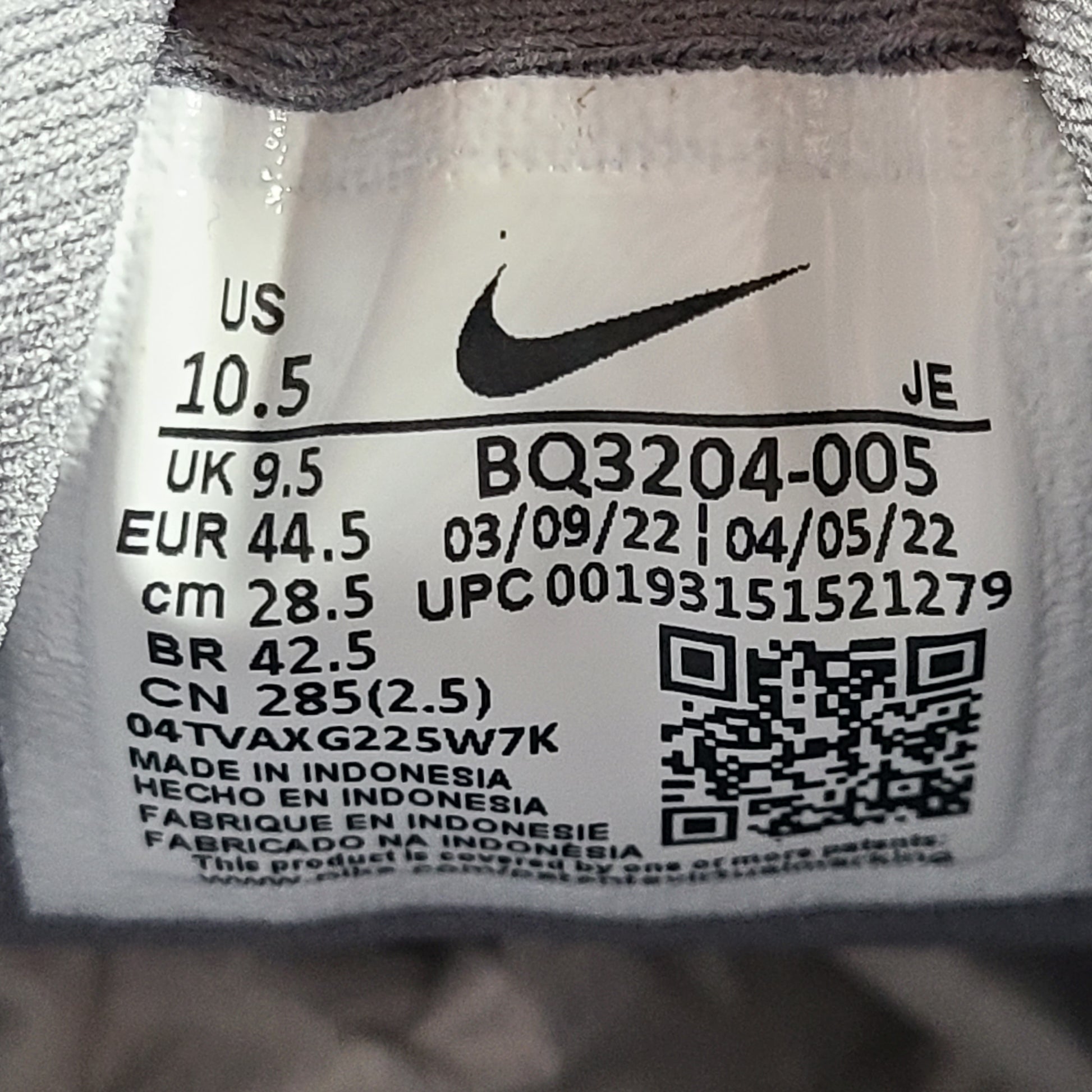 A pair of Nike Revolution 5 Men's Running Shoes in grey and white.