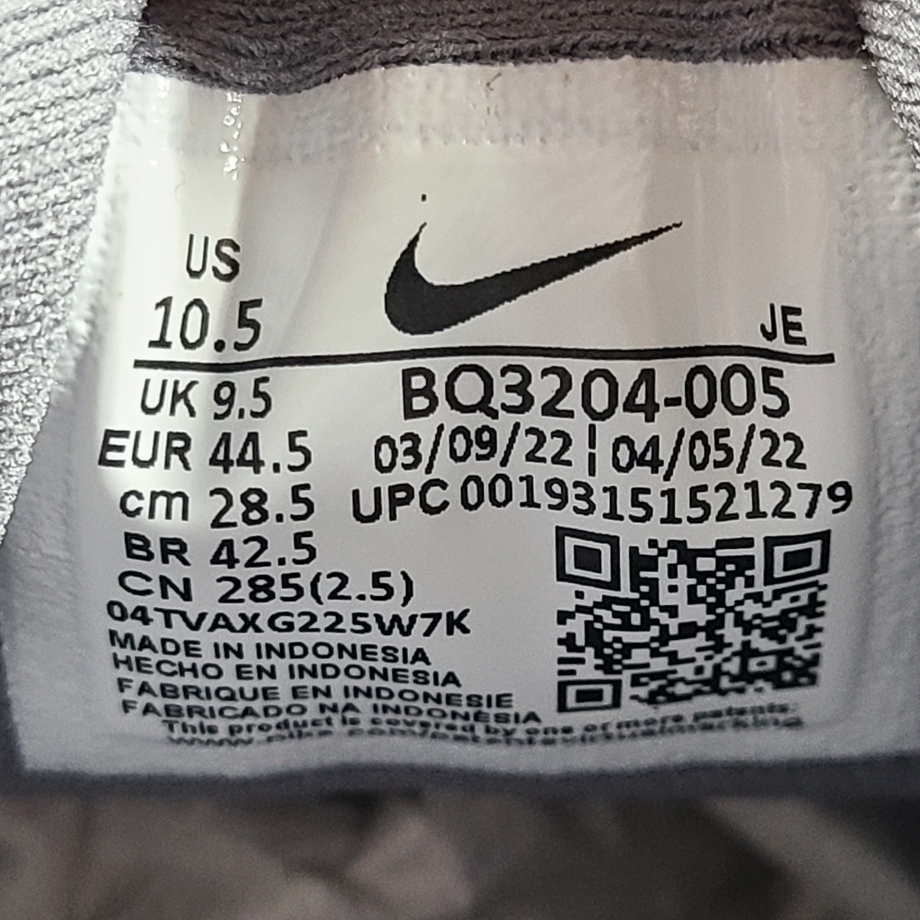 A pair of Nike Revolution 5 Men's Running Shoes in grey and white.