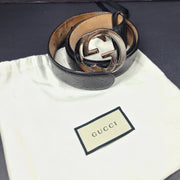 Black Gucci leather belt with interlocking G buckle and a slim, refined profile.
