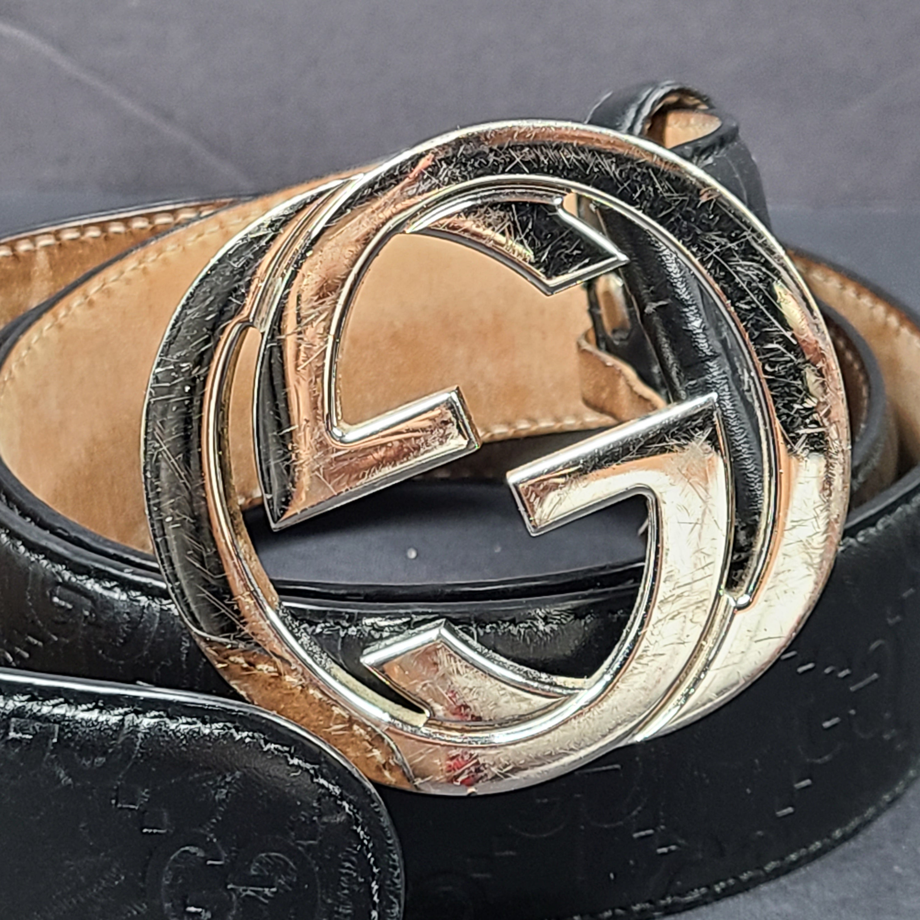Black Gucci leather belt with interlocking G buckle and a slim, refined profile.