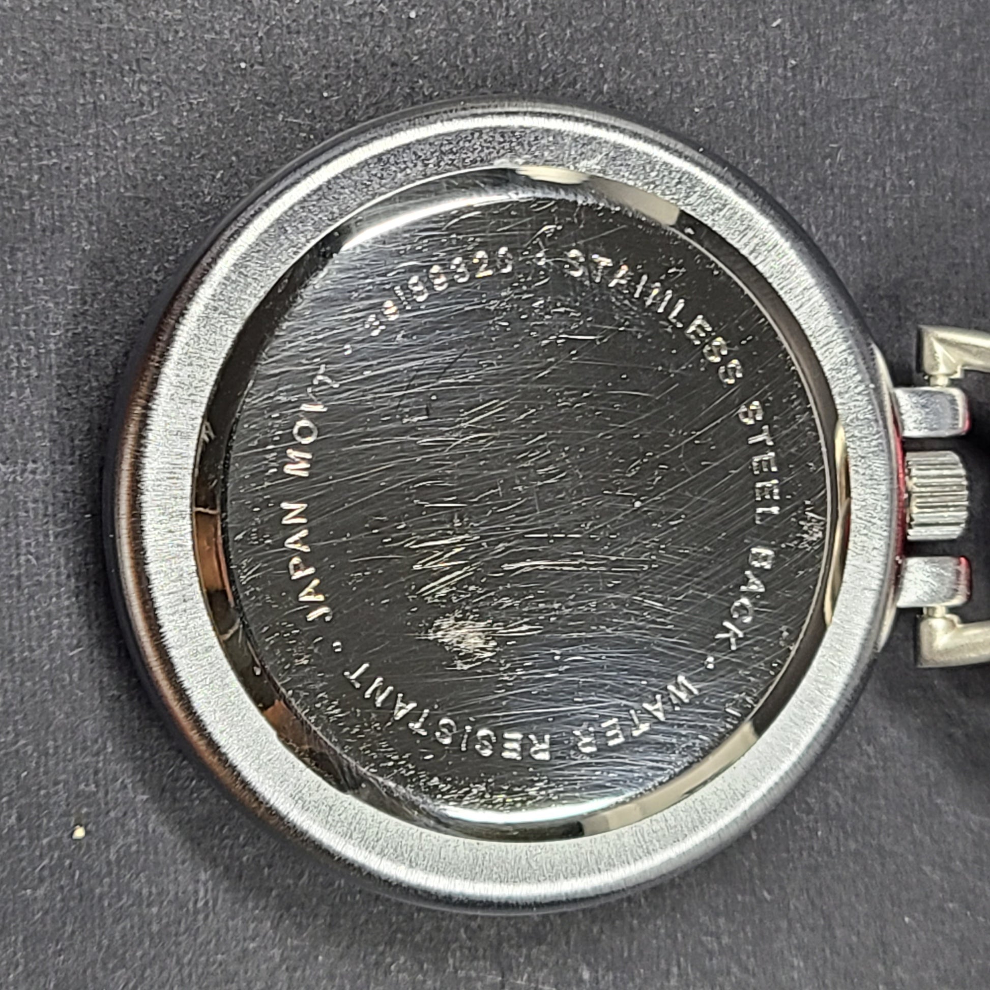 Red and silver pocket watch with a secure carabiner clip, slim profile, and durable construction for active use.