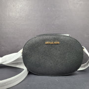 Sleek black Michael Kors crossbody with a signature front logo and a streamlined silhouette for everyday wear.