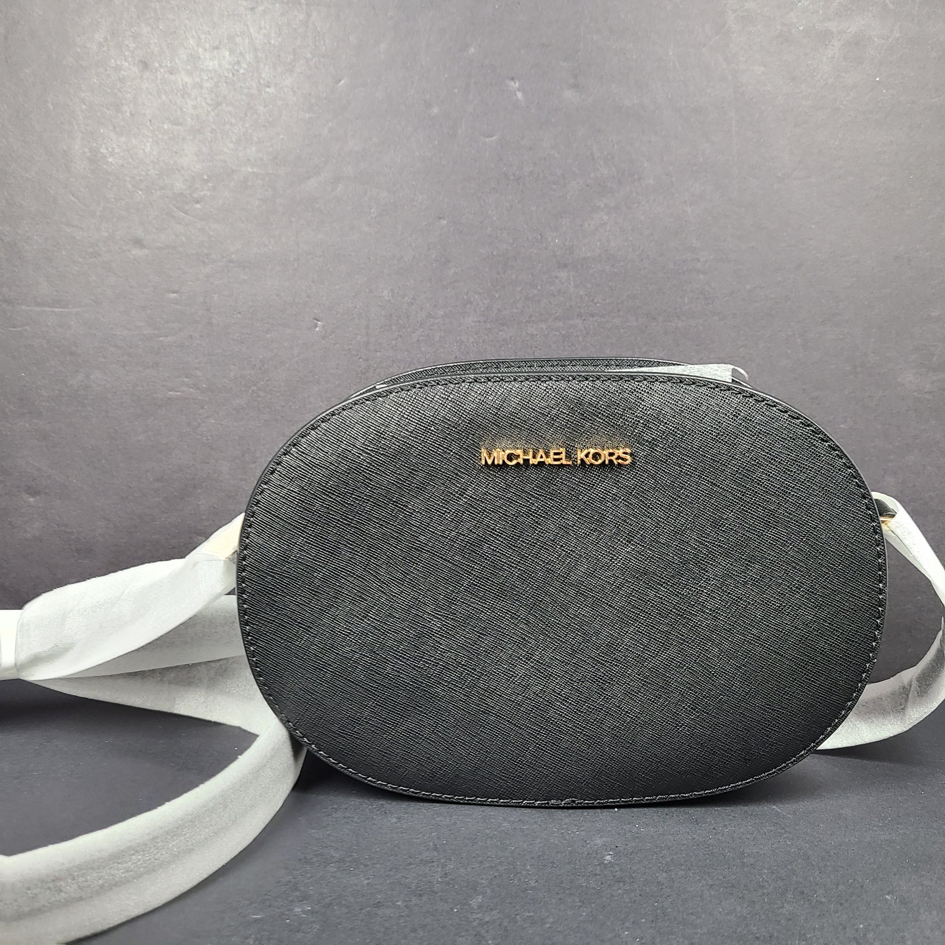 Sleek black Michael Kors crossbody with a signature front logo and a streamlined silhouette for everyday wear.