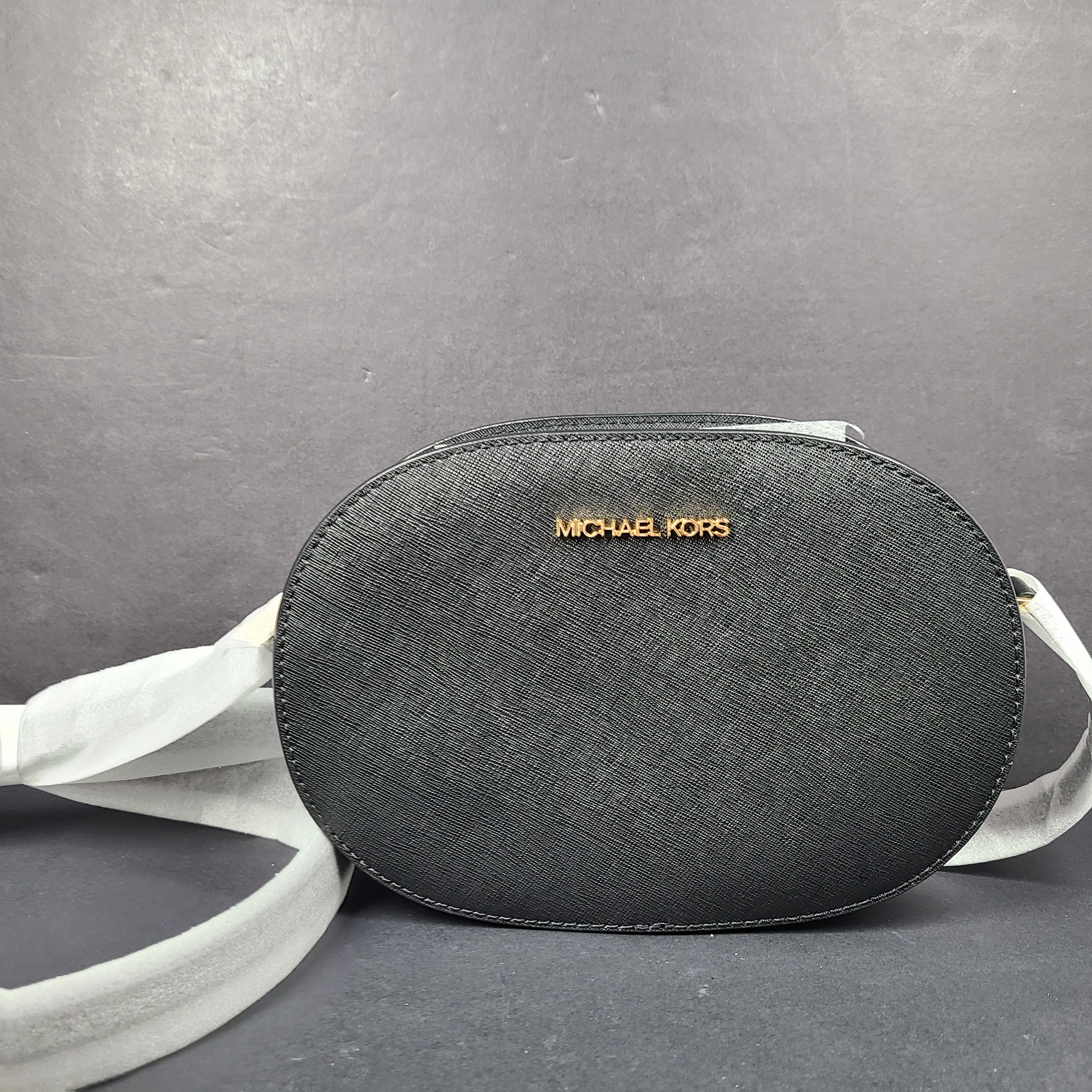 Sleek black Michael Kors crossbody with a signature front logo and a streamlined silhouette for everyday wear.