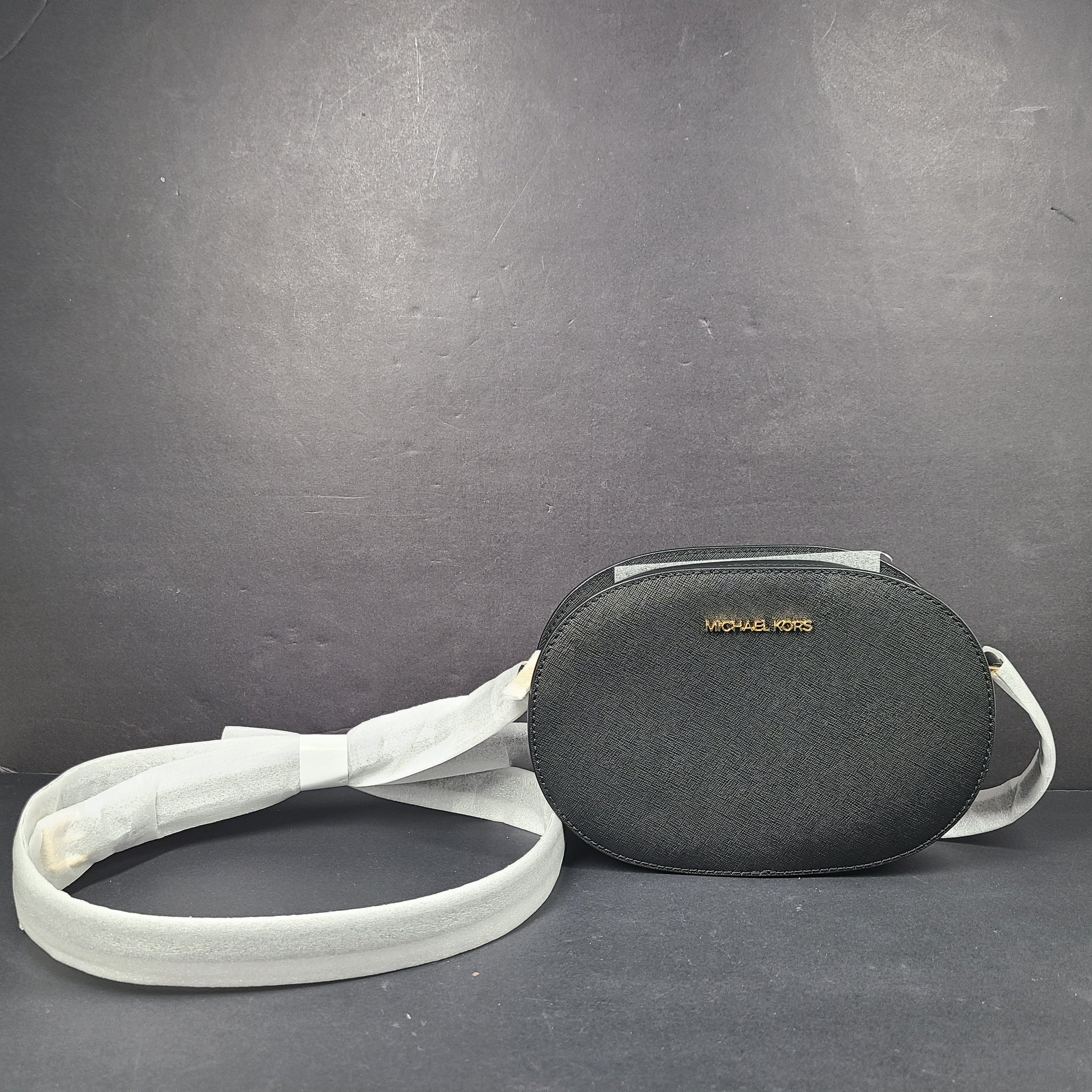 Sleek black Michael Kors crossbody with a signature front logo and a streamlined silhouette for everyday wear.