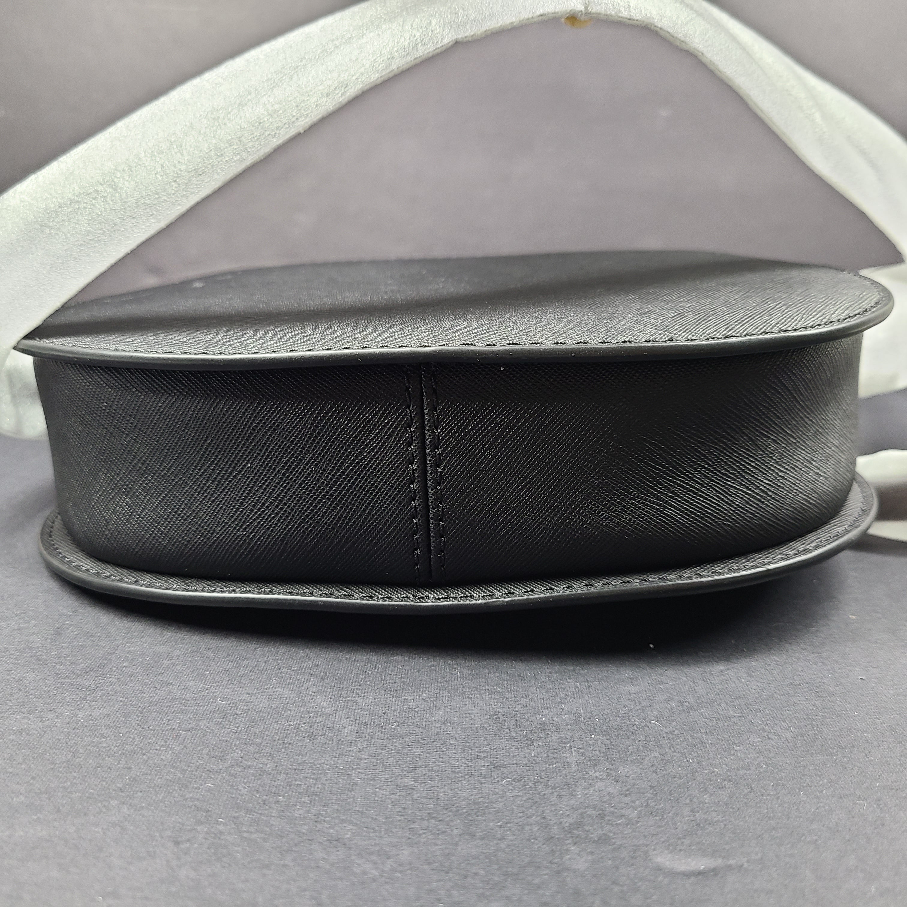 Sleek black Michael Kors crossbody with a signature front logo and a streamlined silhouette for everyday wear.