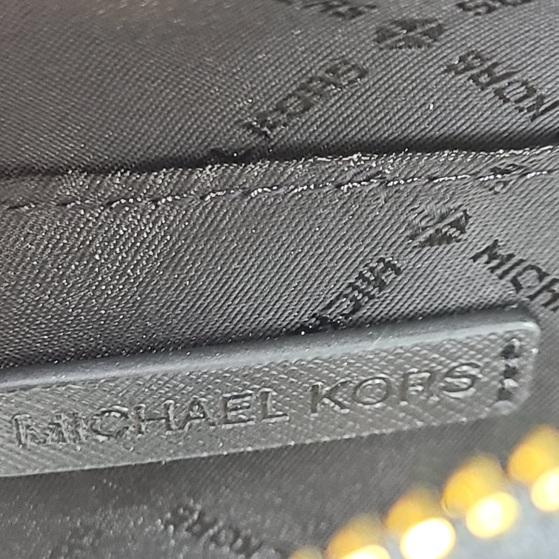 Sleek black Michael Kors crossbody with a signature front logo and a streamlined silhouette for everyday wear.