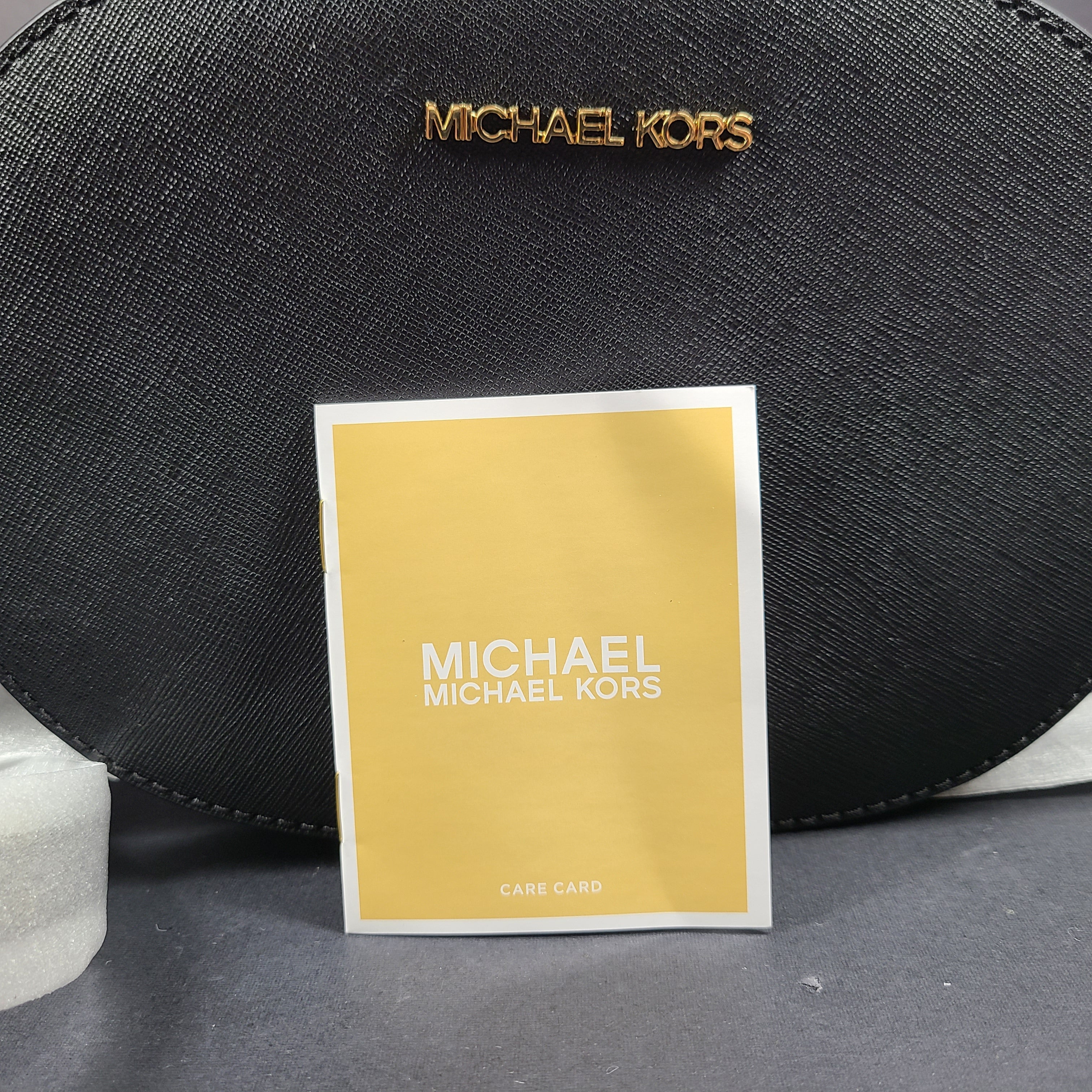 Sleek black Michael Kors crossbody with a signature front logo and a streamlined silhouette for everyday wear.