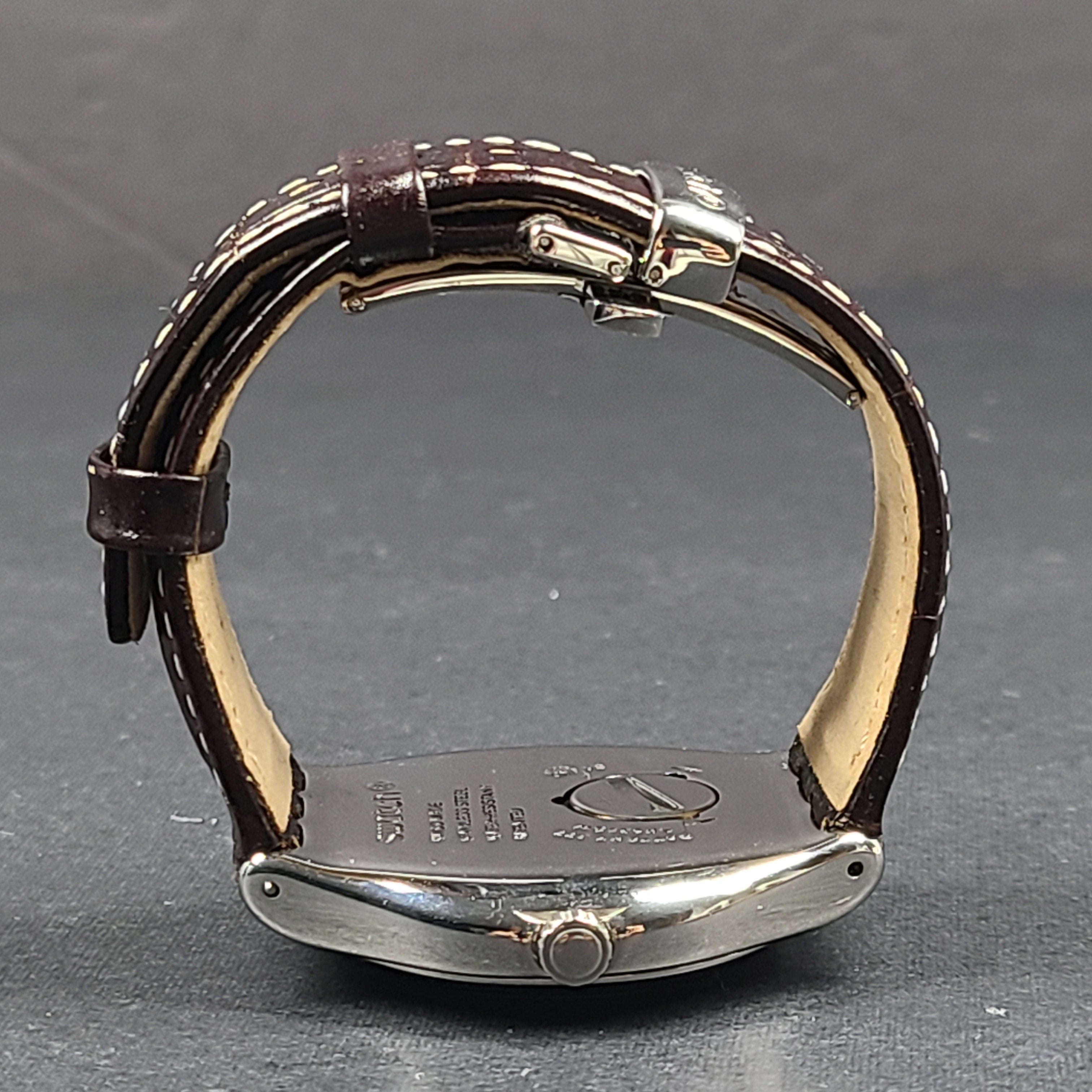 Swatch YGS452G stainless steel wristwatch with a white dial and brown leather strap.