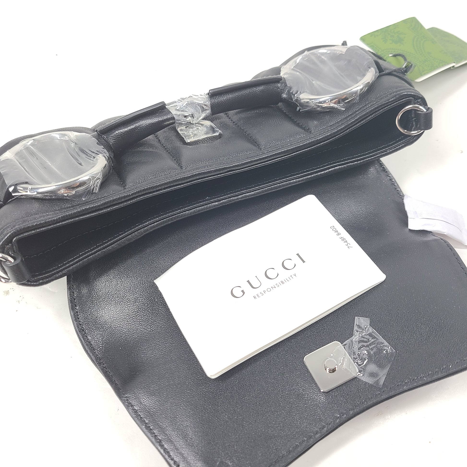 Slim black Gucci 103030 leather handbag with signature interior logo and versatile carry options for everyday elegance.