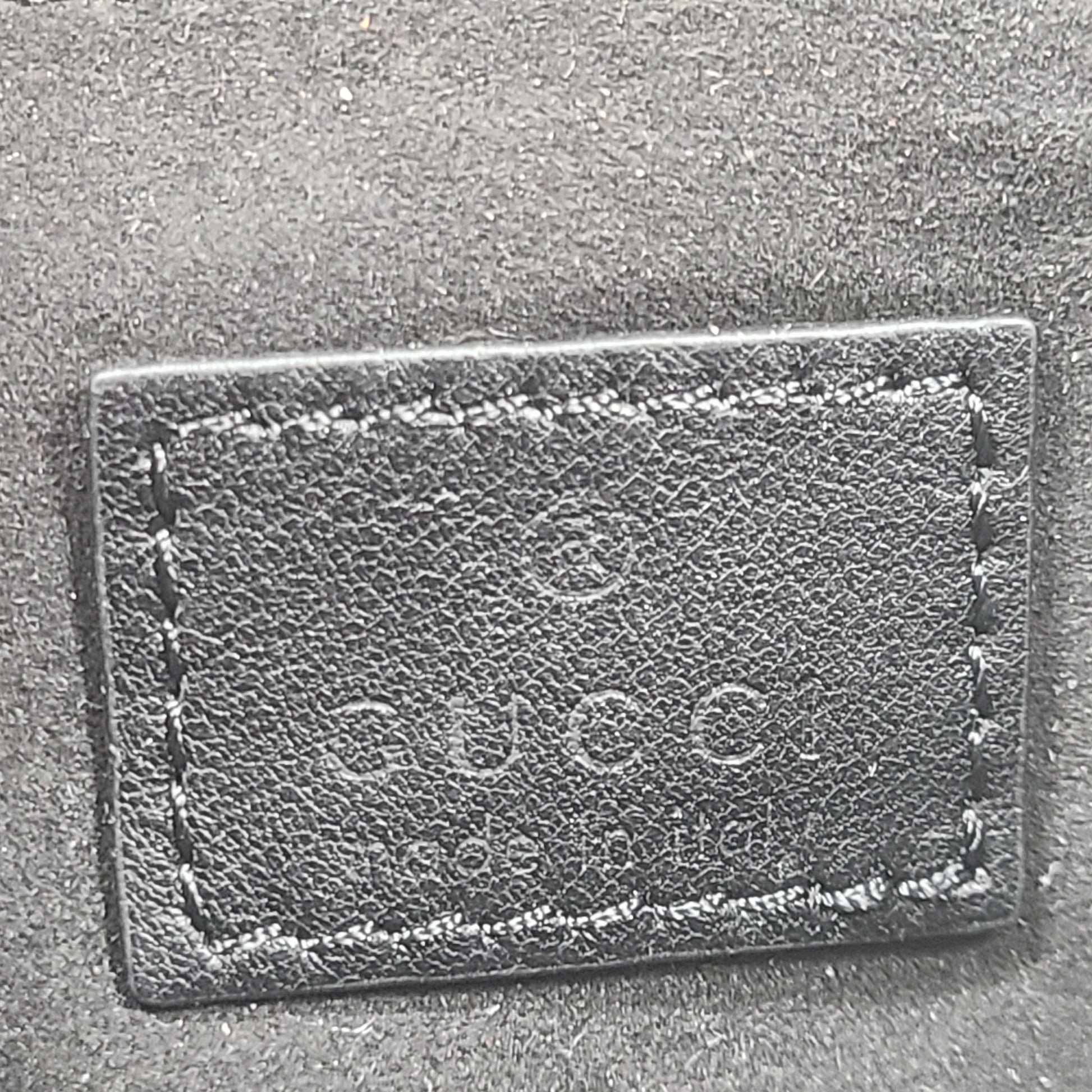Slim black Gucci 103030 leather handbag with signature interior logo and versatile carry options for everyday elegance.