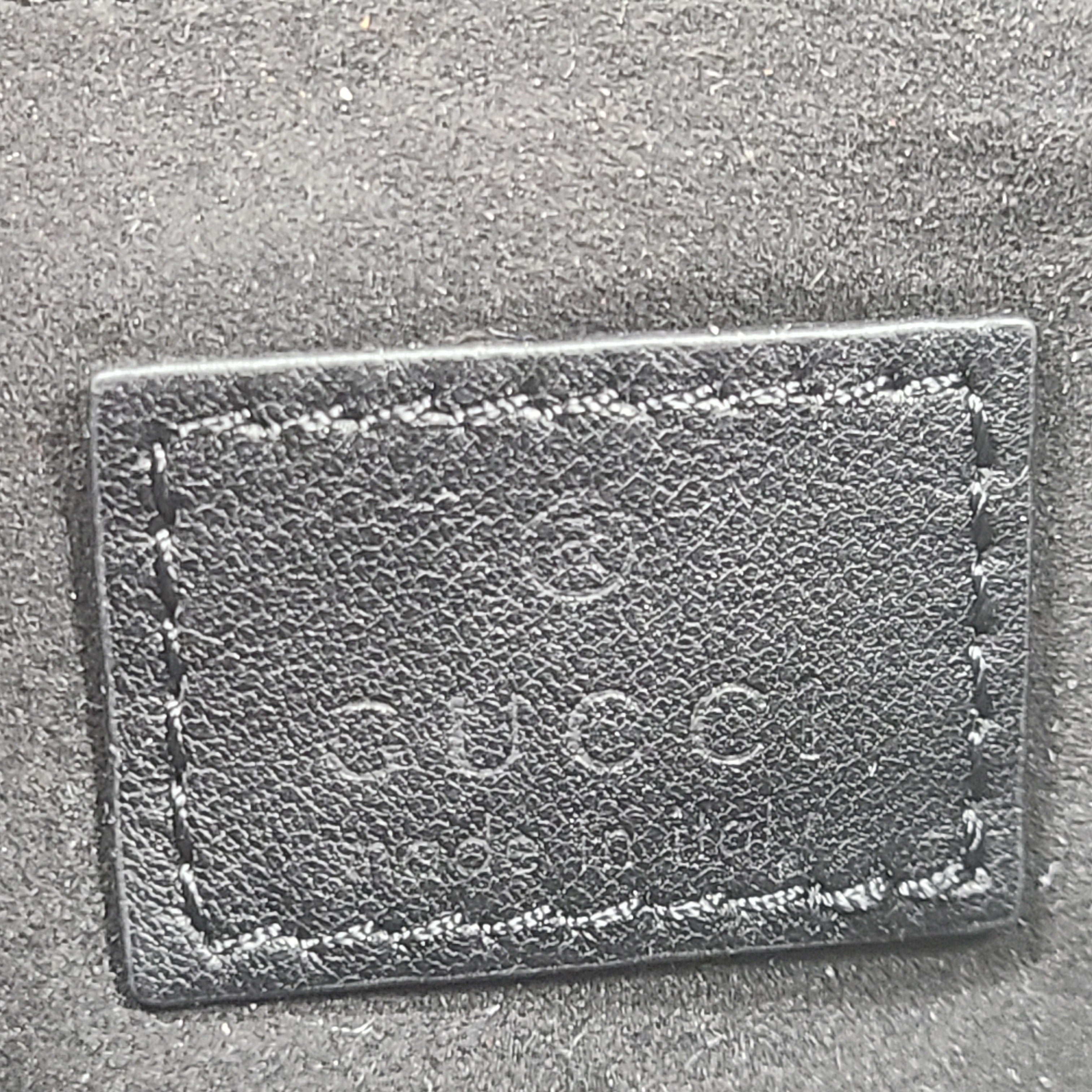 Slim black Gucci 103030 leather handbag with signature interior logo and versatile carry options for everyday elegance.