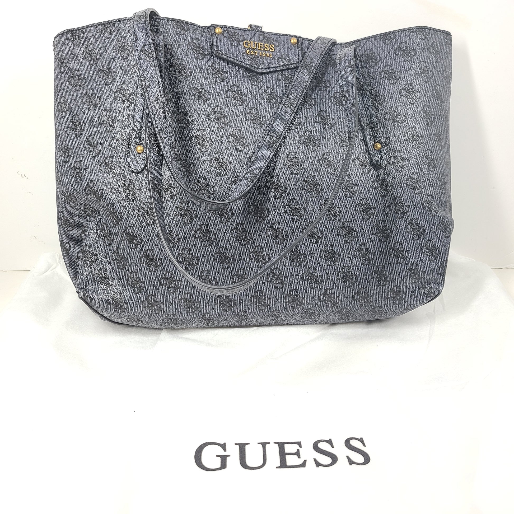 Grey GUESS monogram tote with gold-tone hardware and a matching pouch for organized everyday carry.