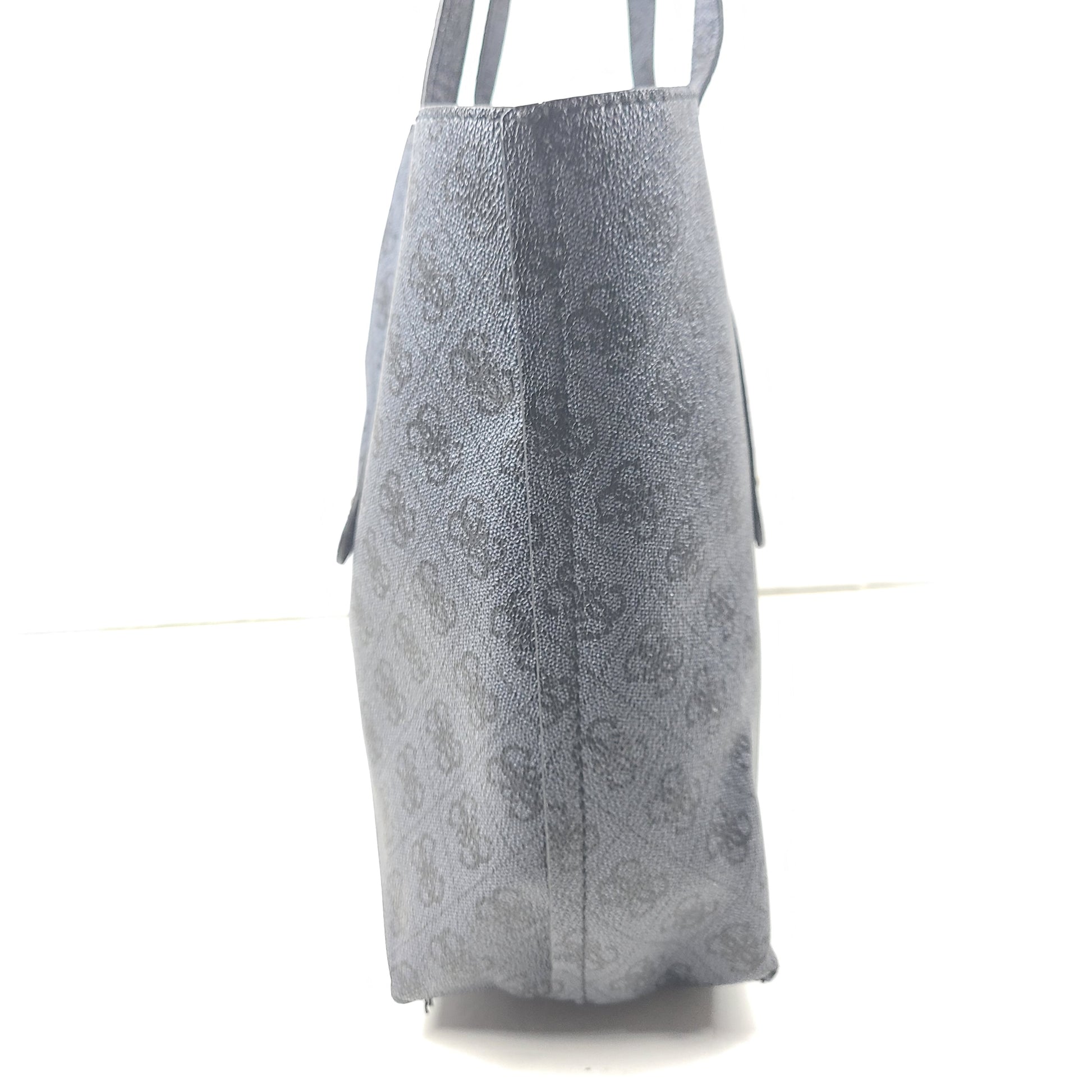 Grey GUESS monogram tote with gold-tone hardware and a matching pouch for organized everyday carry.