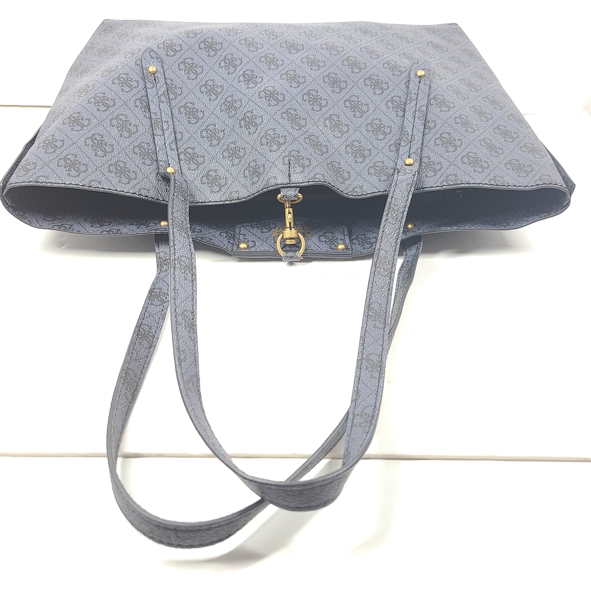 Grey GUESS monogram tote with gold-tone hardware and a matching pouch for organized everyday carry.