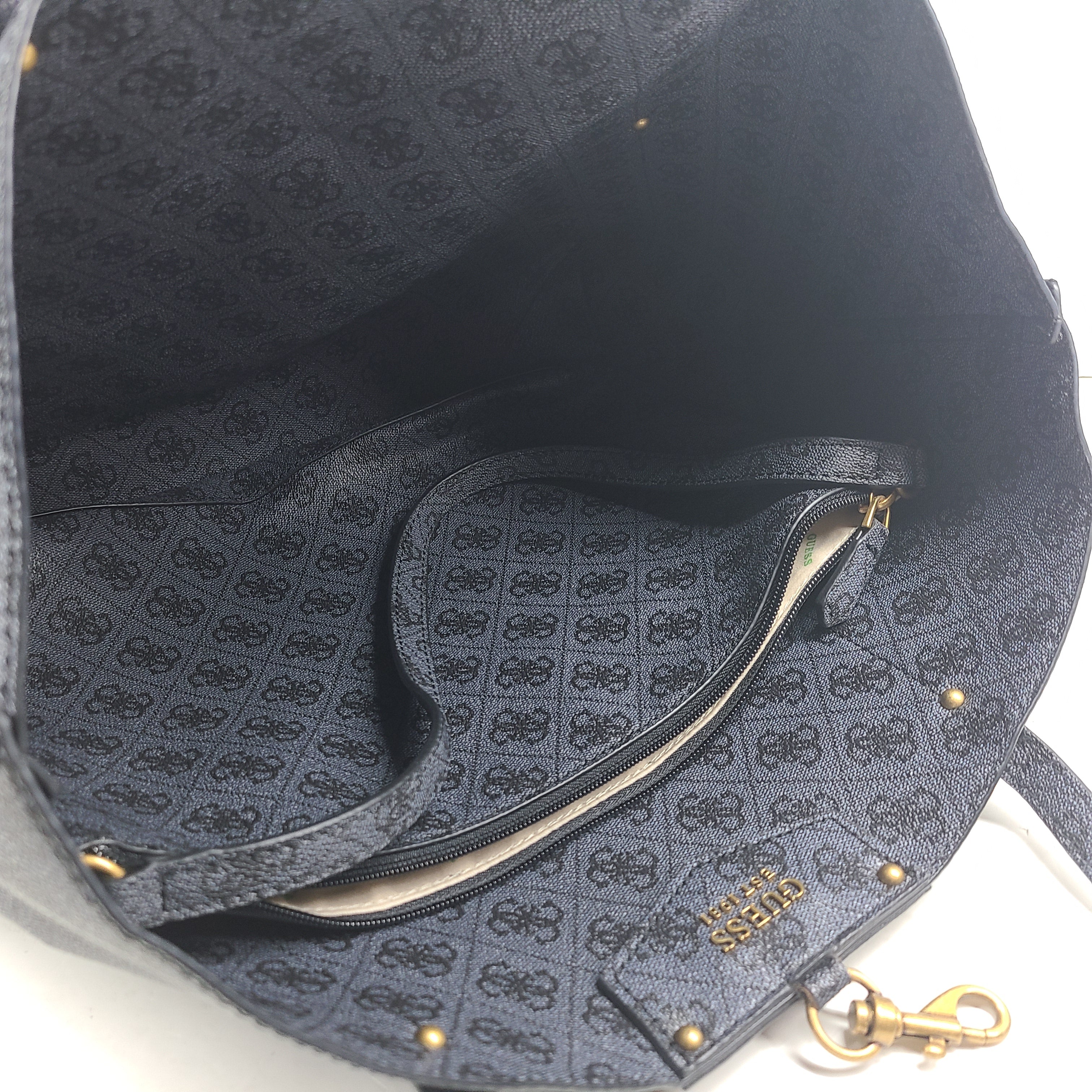 Grey GUESS monogram tote with gold-tone hardware and a matching pouch for organized everyday carry.