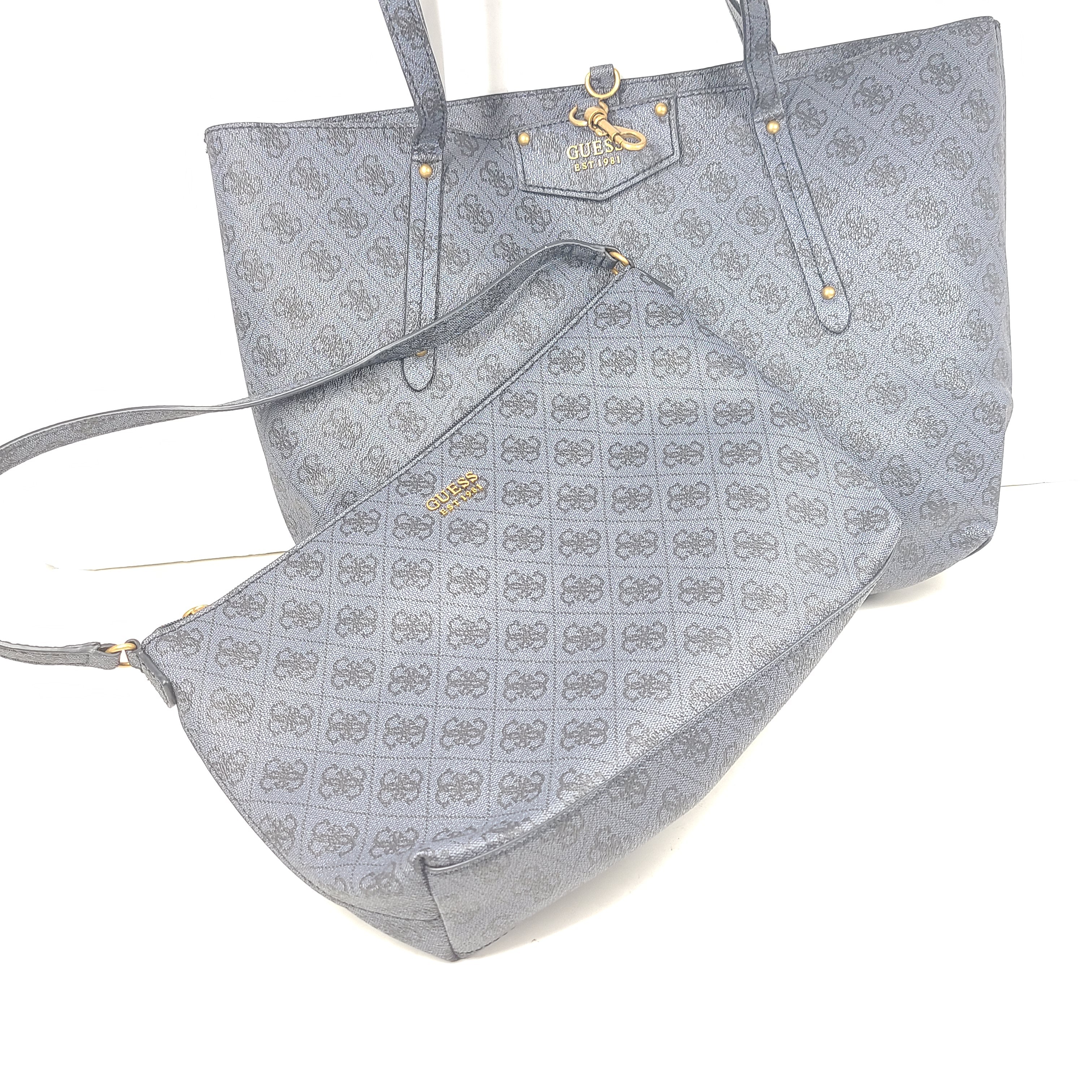 Grey GUESS monogram tote with gold-tone hardware and a matching pouch for organized everyday carry.