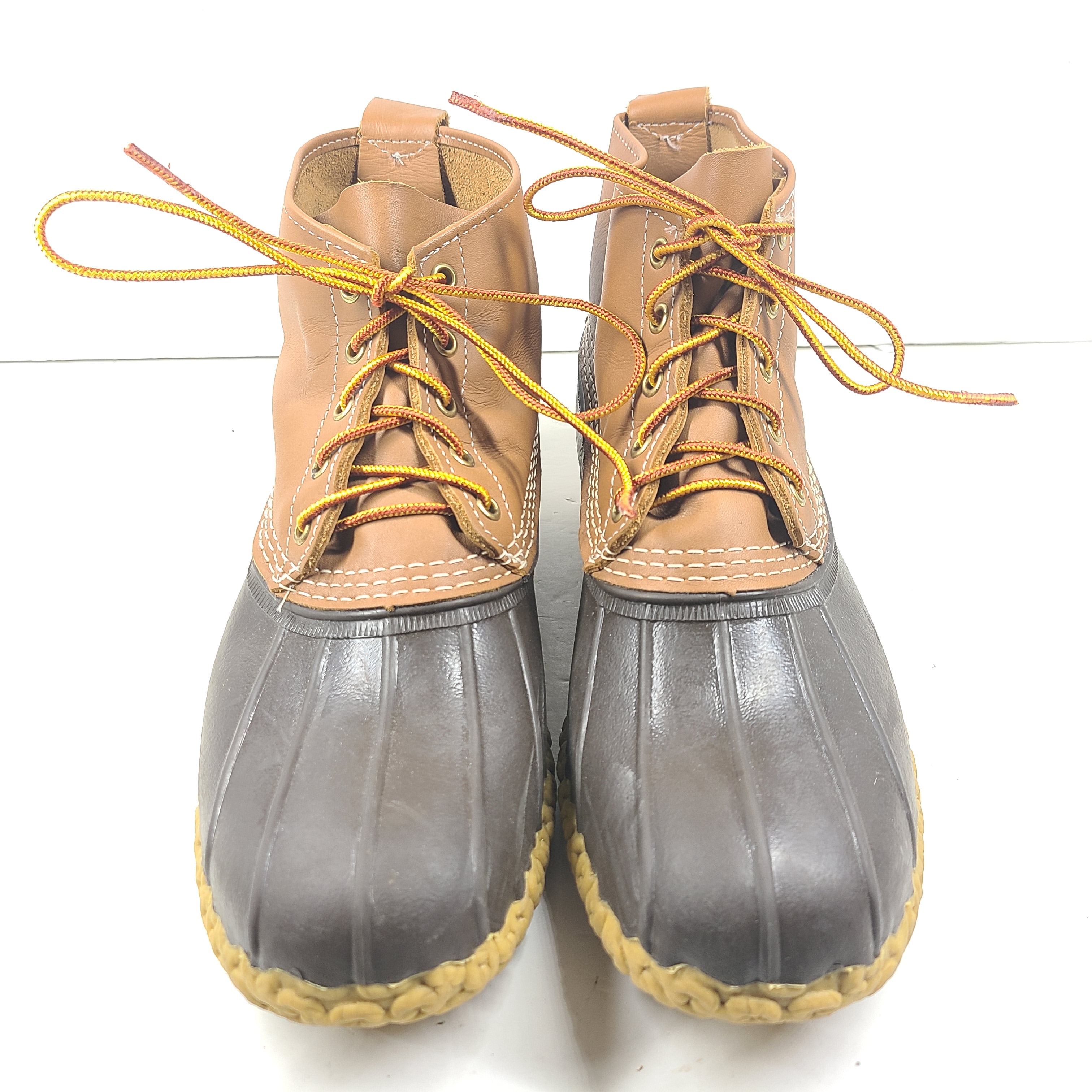 Classic L.L. Bean brown and tan leather boots that offer durable outdoor traction and timeless style.