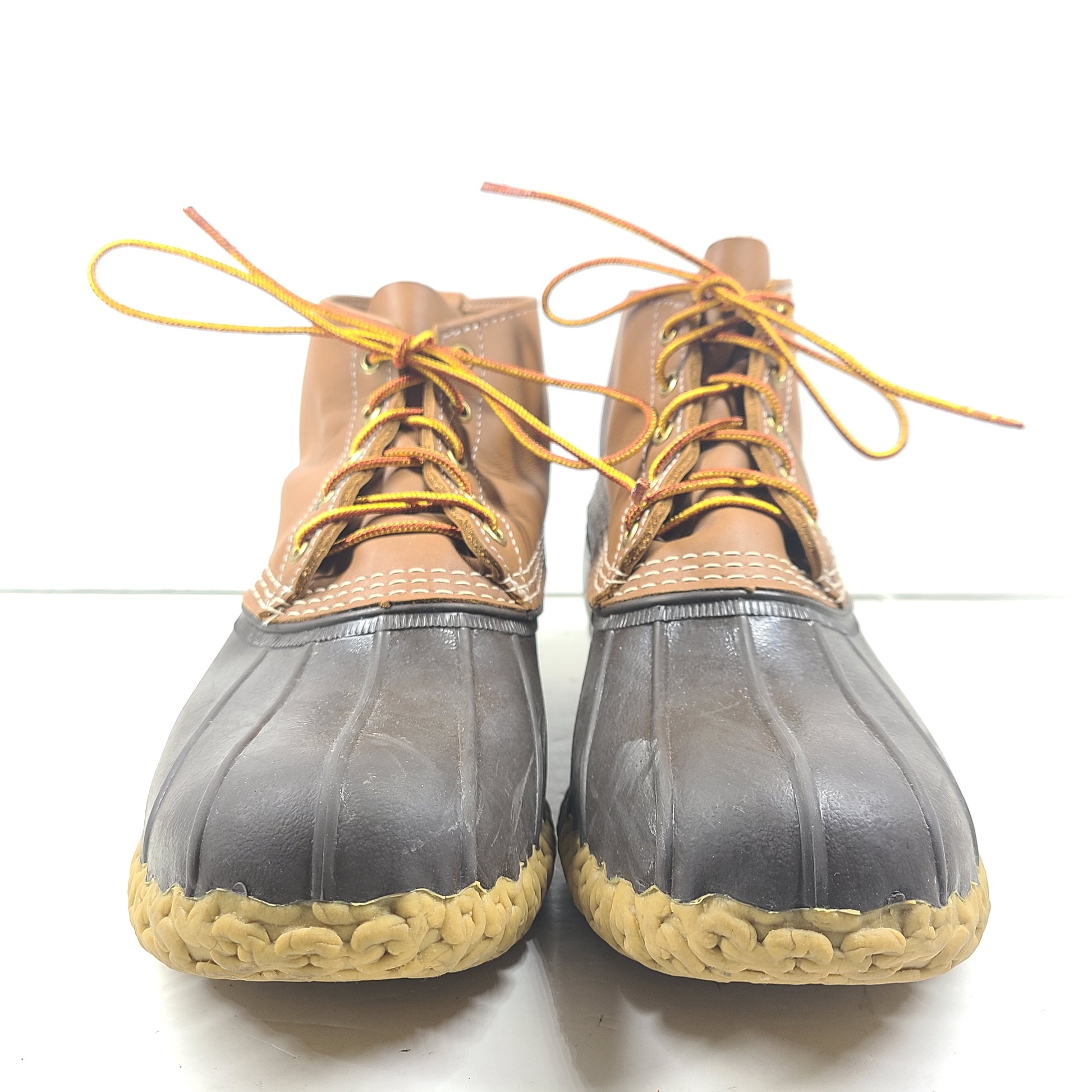 Classic L.L. Bean brown and tan leather boots that offer durable outdoor traction and timeless style.