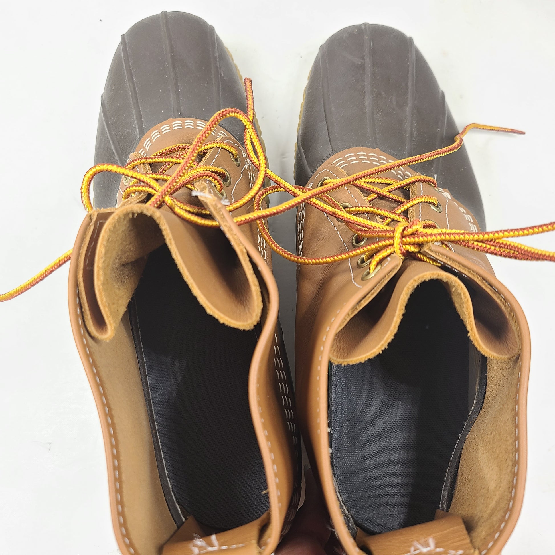 Classic L.L. Bean brown and tan leather boots that offer durable outdoor traction and timeless style.