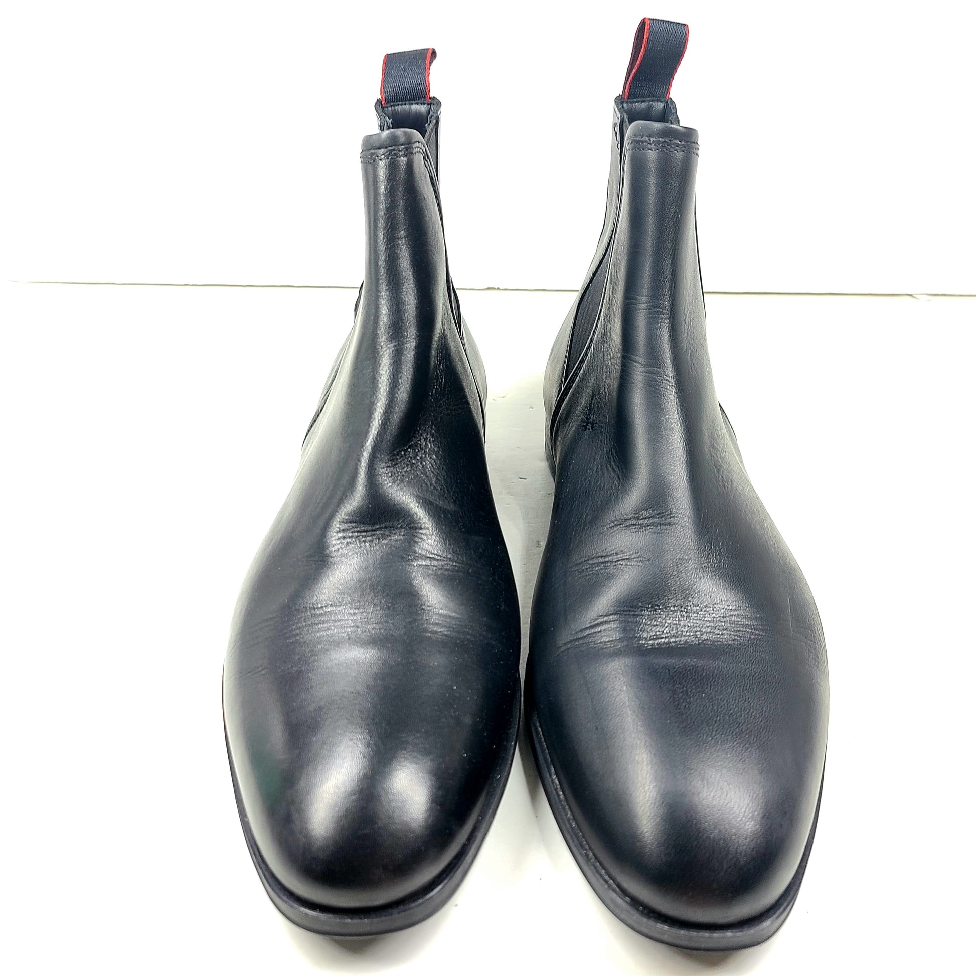 Black leather Chelsea boots by Hugo Boss with a sleek ankle silhouette and branded insole.