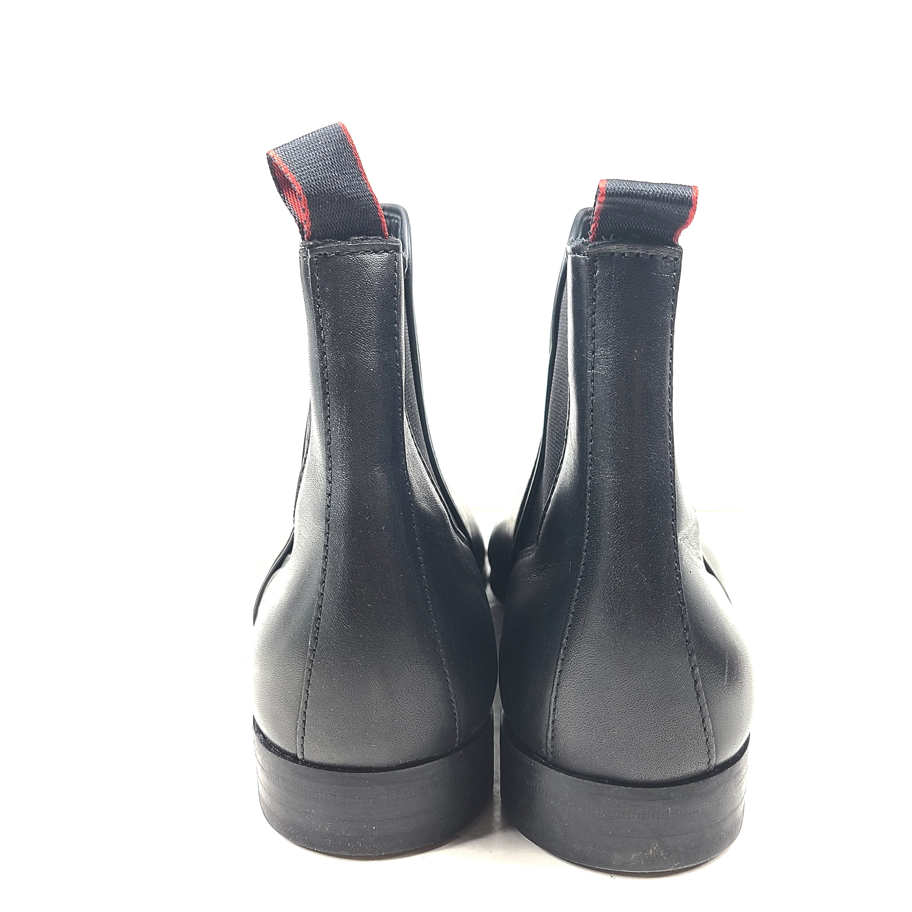 Black leather Chelsea boots by Hugo Boss with a sleek ankle silhouette and branded insole.