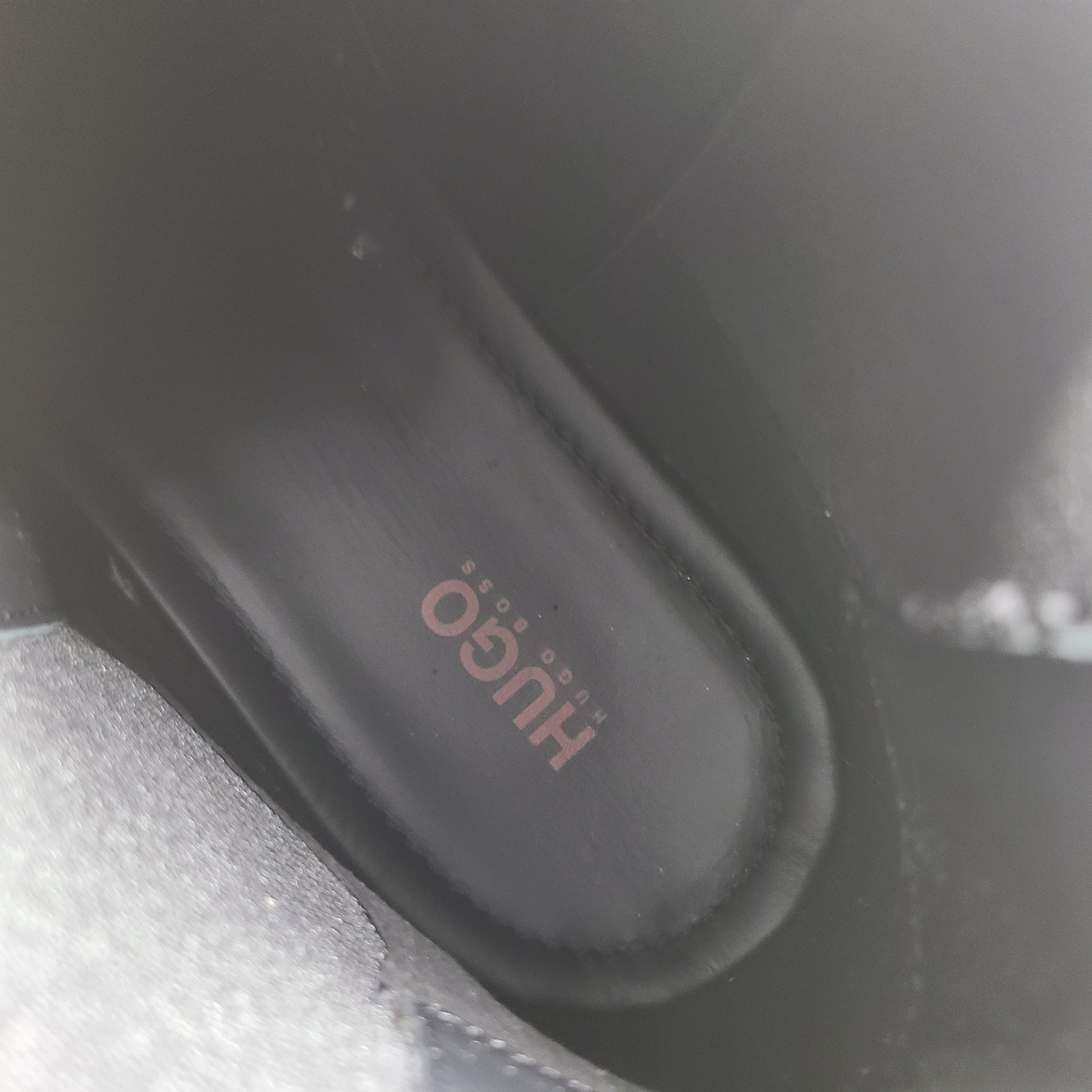 Black leather Chelsea boots by Hugo Boss with a sleek ankle silhouette and branded insole.