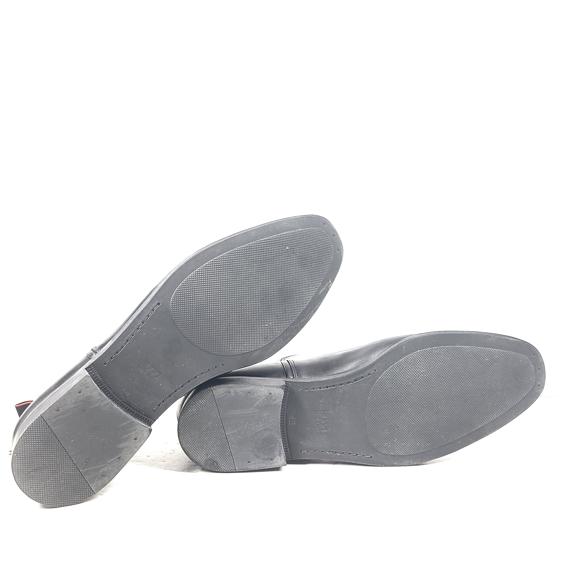 Black leather Chelsea boots by Hugo Boss with a sleek ankle silhouette and branded insole.
