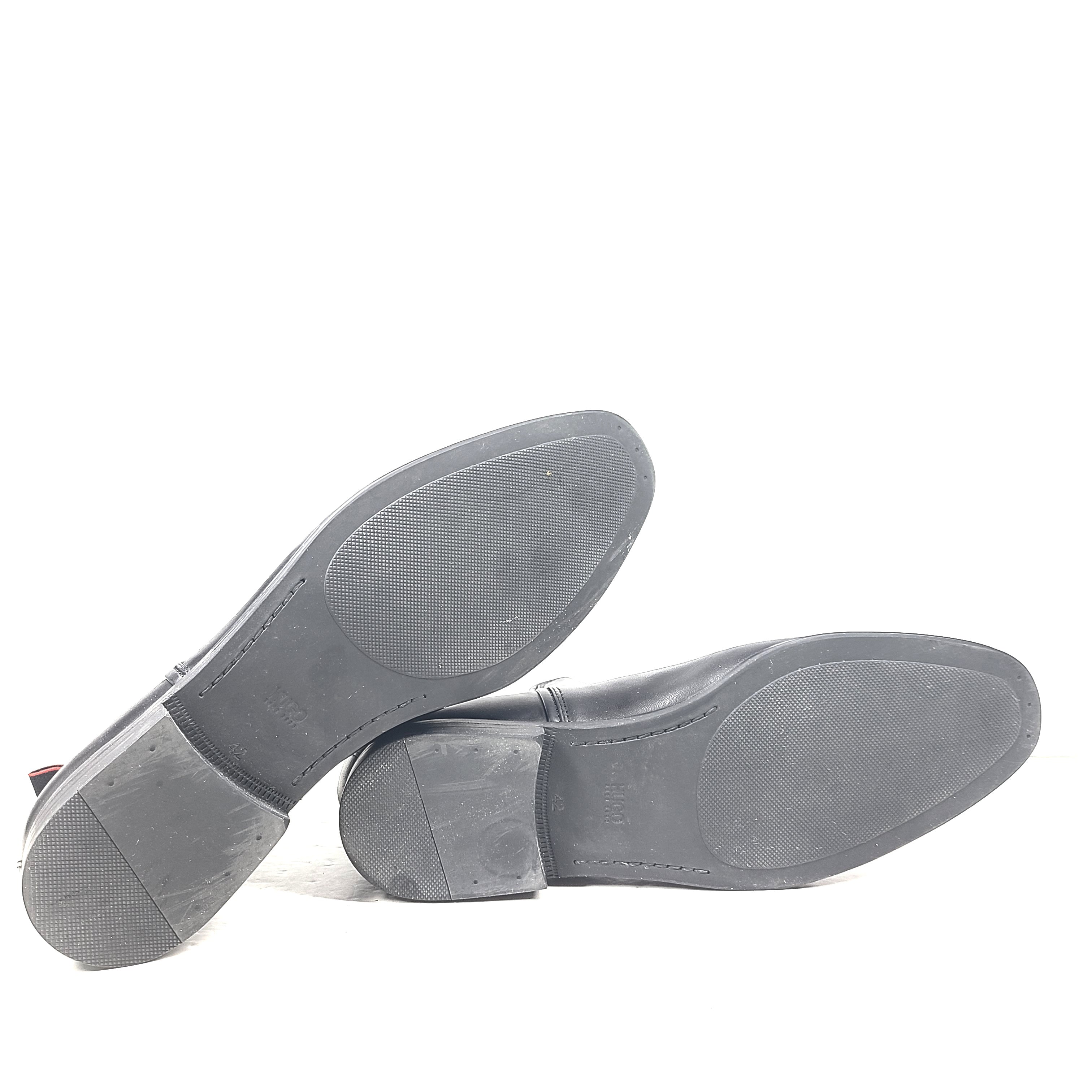 Black leather Chelsea boots by Hugo Boss with a sleek ankle silhouette and branded insole.