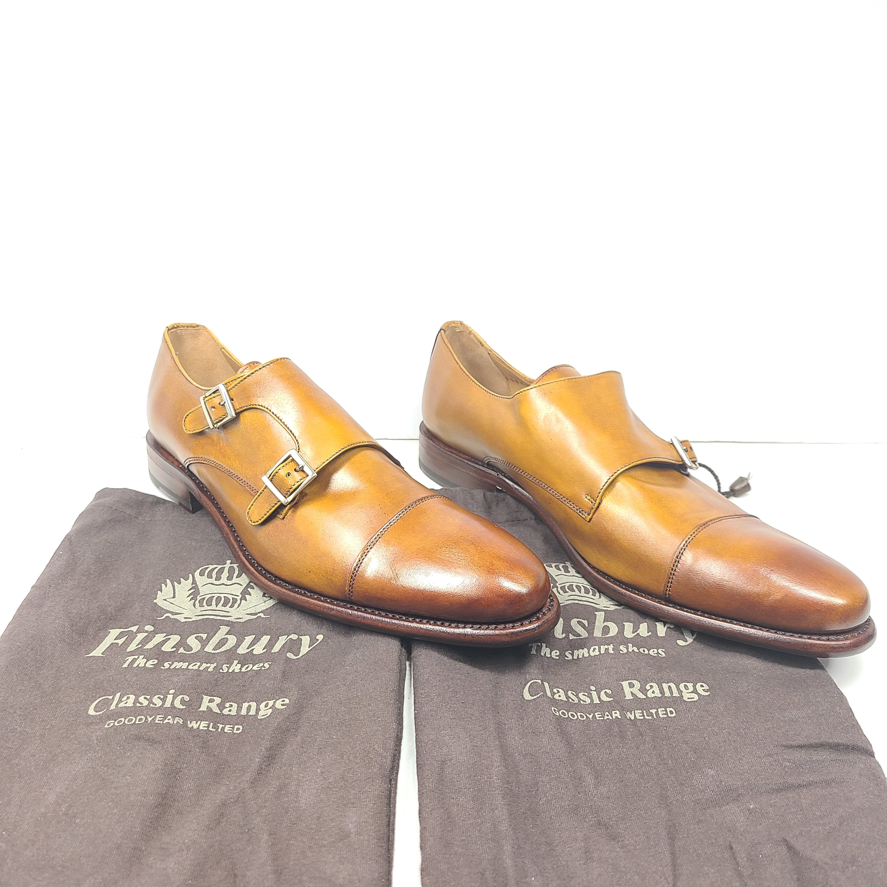 Brown Goodyear-welted leather dress shoes with a refined rounded silhouette and stacked heel.