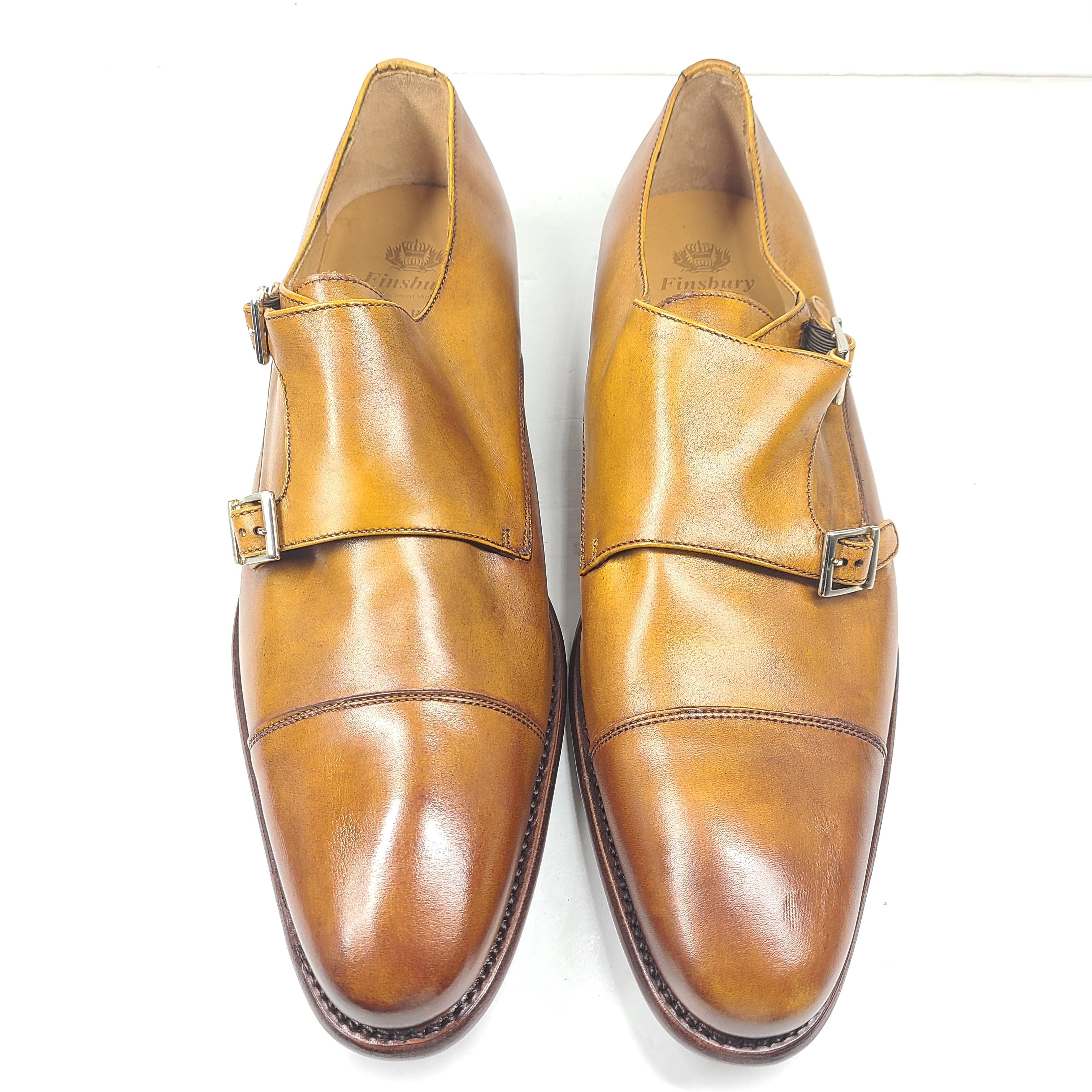 Brown Goodyear-welted leather dress shoes with a refined rounded silhouette and stacked heel.